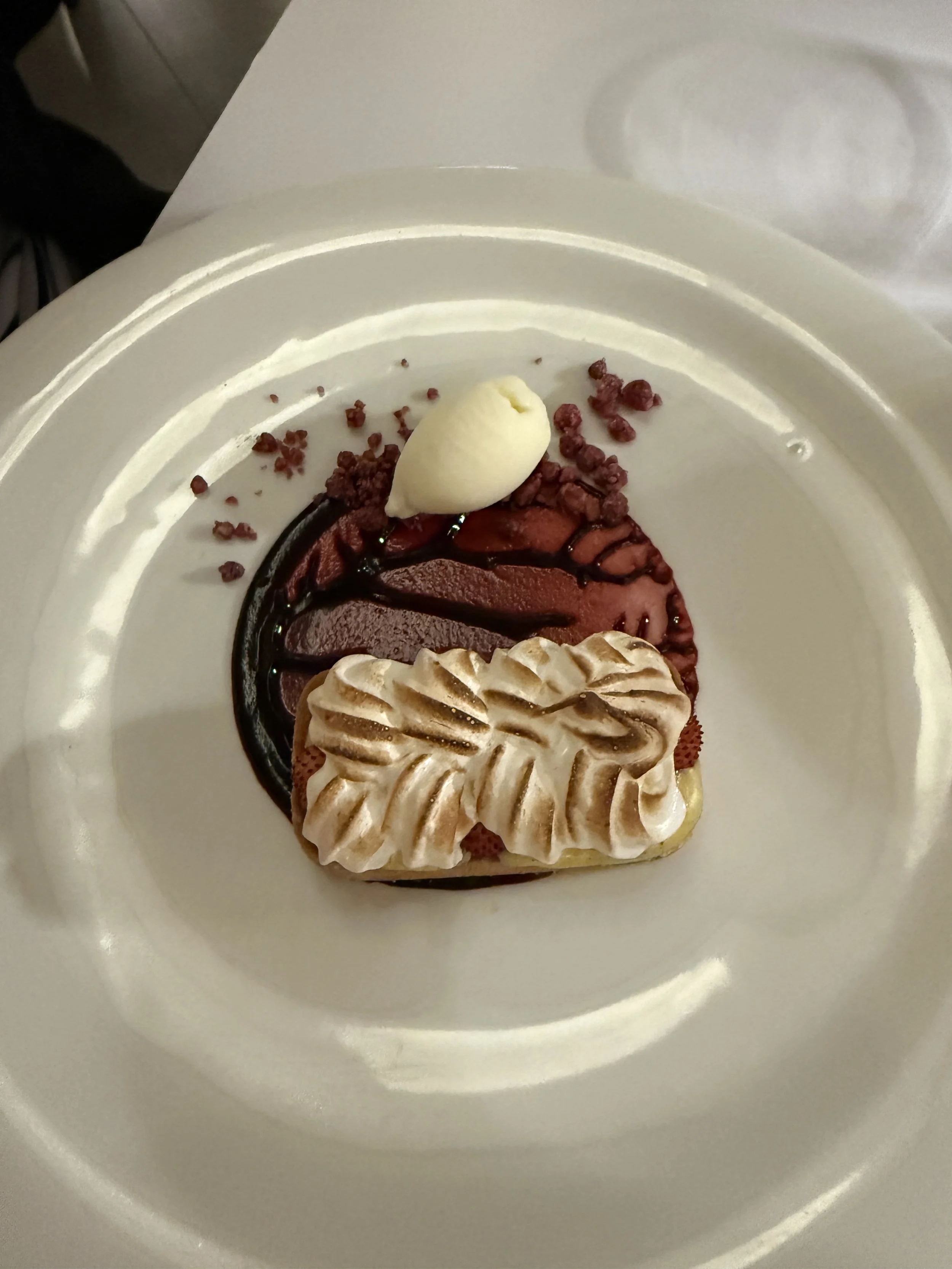 Wild strawberry tart with foam of warm meringue, and blueberries sauce.