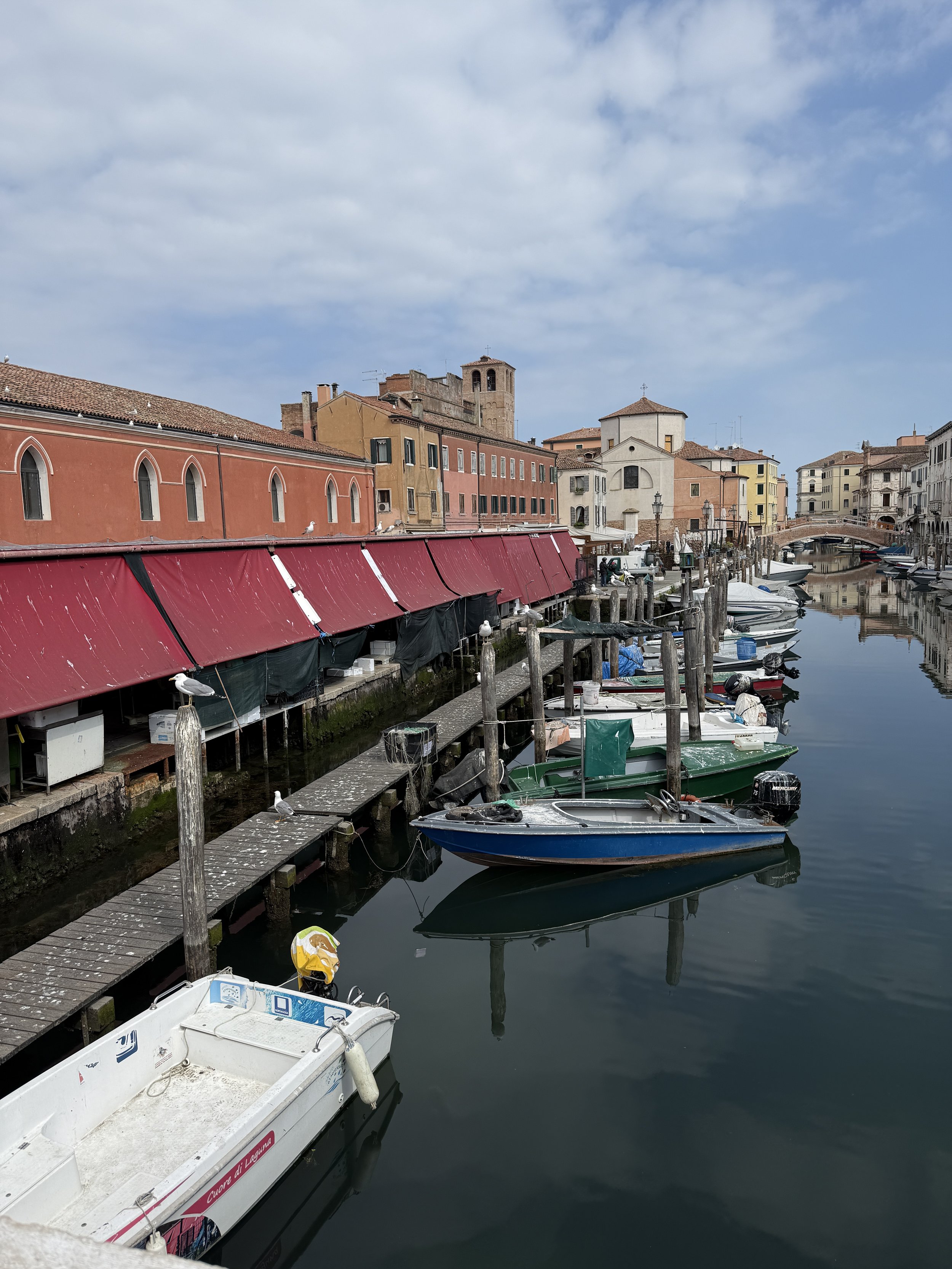 Fish Market on the left with boats brining in the fresh catch