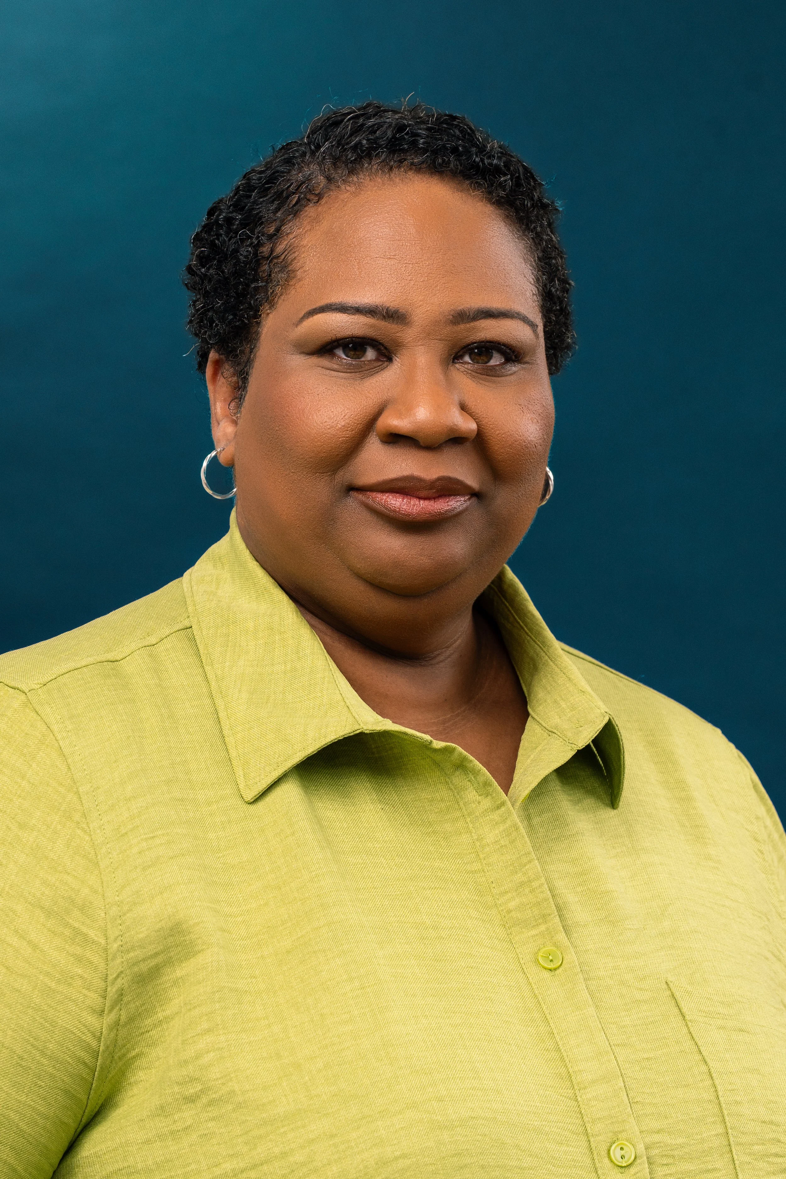 Mukani actor headshot studio blue background — professional NYC headshots