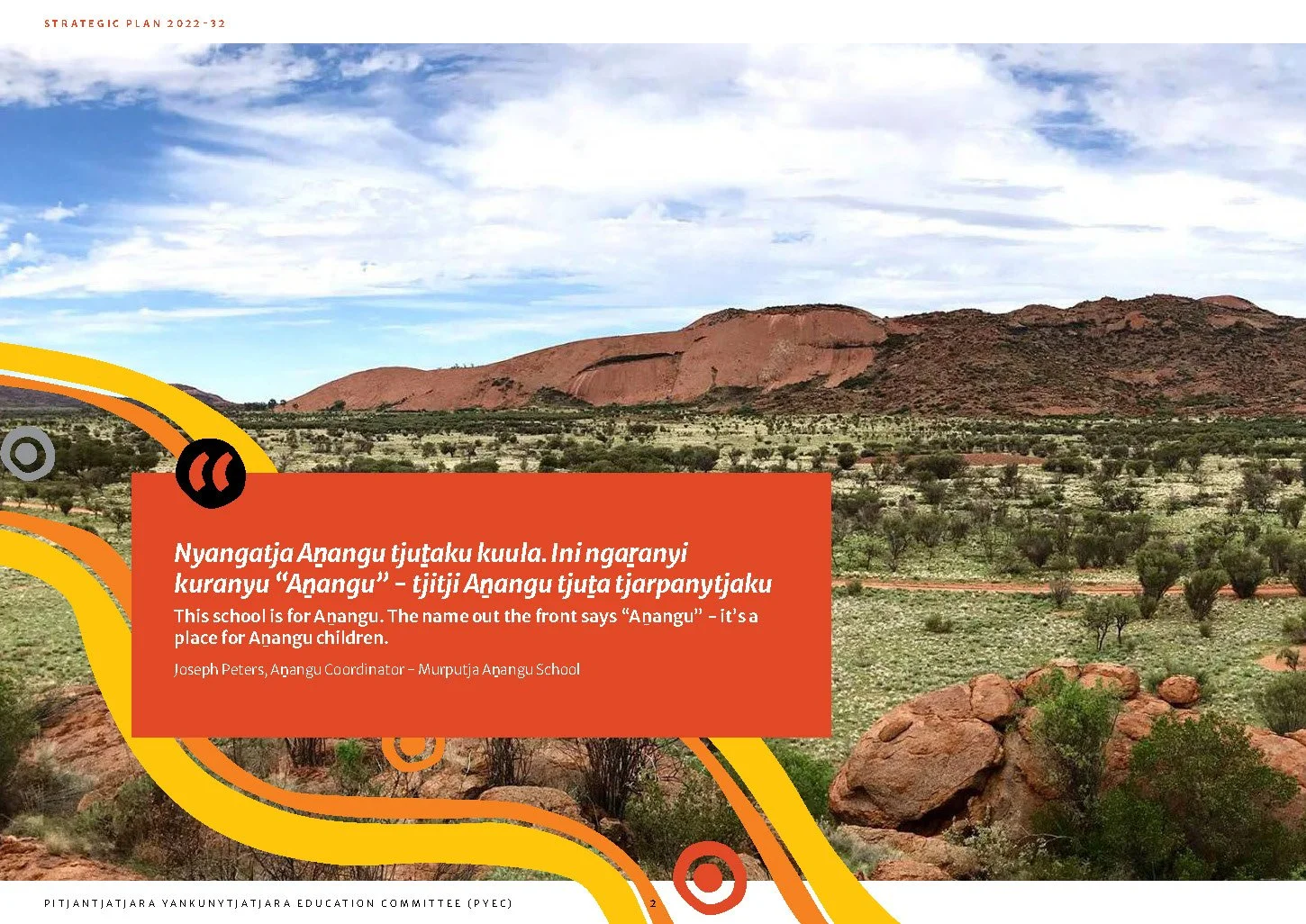 A landscape with reddish hills and sparse green vegetation under a partly cloudy sky, with a graphic overlay containing a quote about a school for Anangu children.