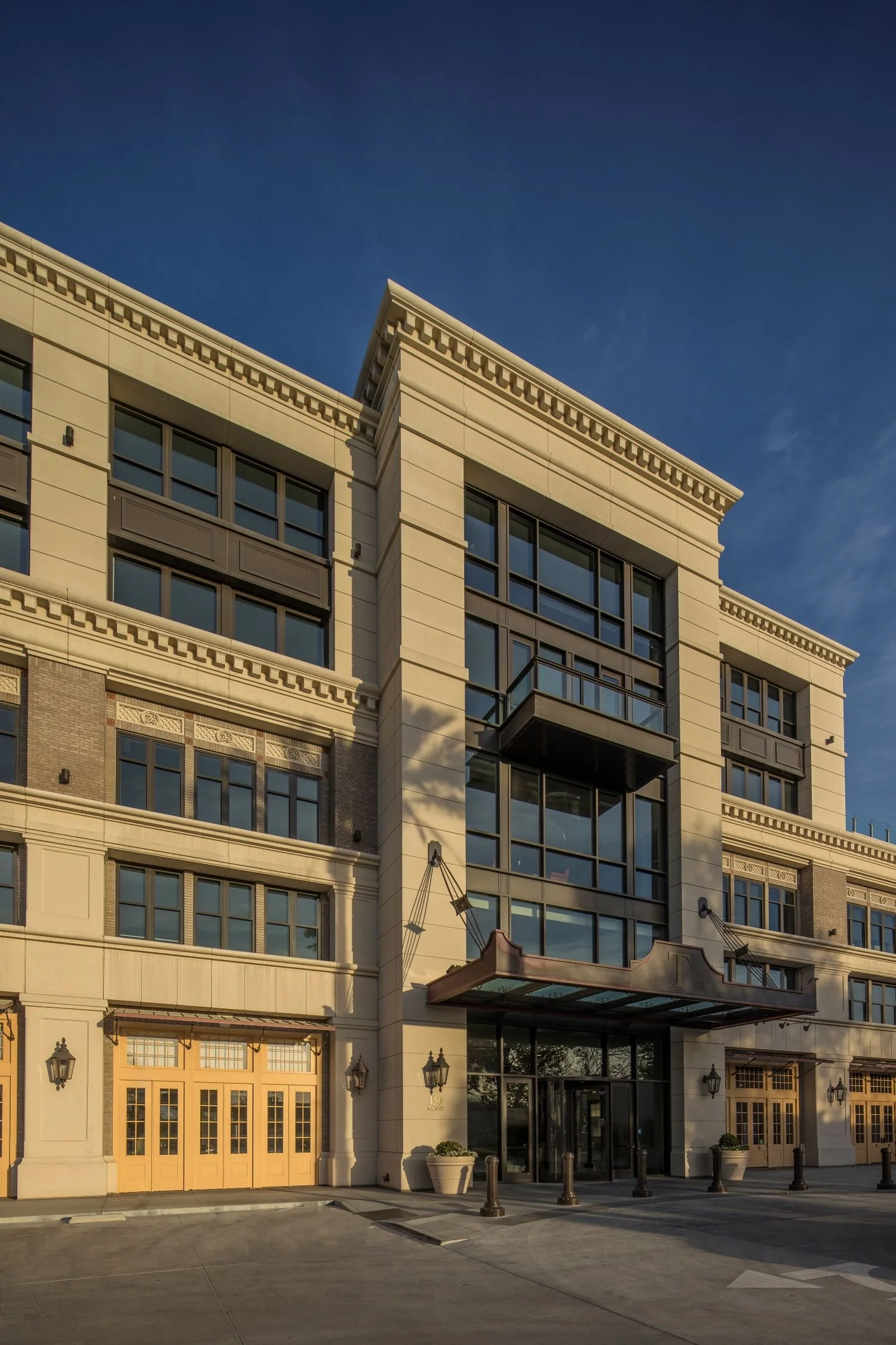 A grand, multi-story building with a classic architectural design, featuring large windows and an inviting entrance.