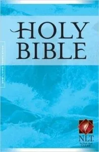 Cover of a Bible with a blue background and the title 'Holy Bible' in large black letters, with a small red and gold seal in the bottom right corner.