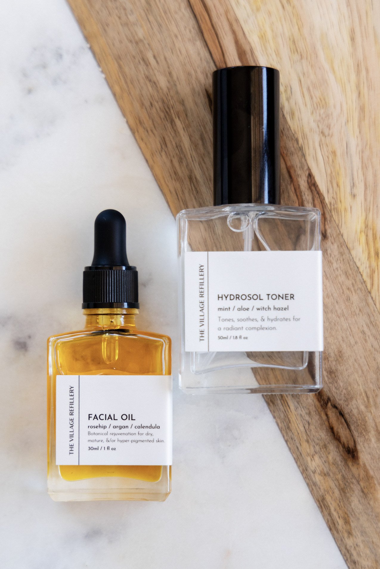 glass dropper bottle and glass atomizer bottle with white label and black text reading "facial oil" and "hydrosol toner" respectively