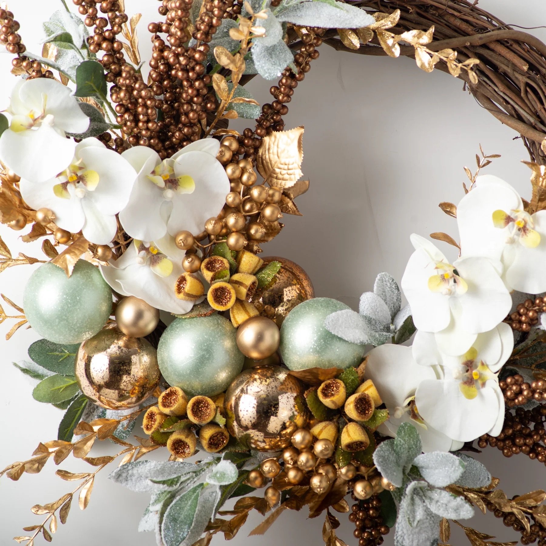 CW1252_7_GoldenHourMist-WhiteOrchid_GildedBerry_Boxwood_IcedLamb_sEar_SeafoamwithCopperOrnamentBallAsymmetricalChristmasWreath_1800x1800 2.jpeg