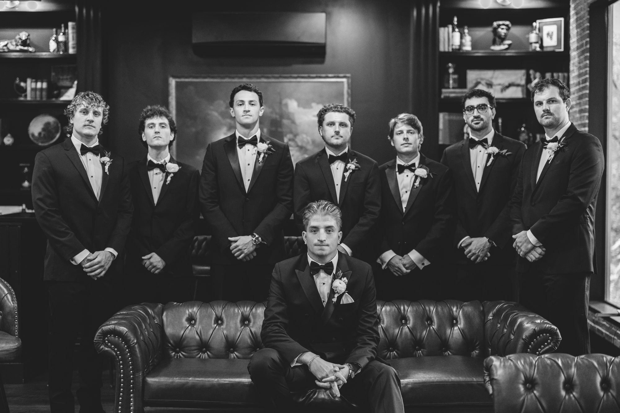 Black and white photo of the groomsmen in the groom's room at Whitewood Ranch wedding venue
