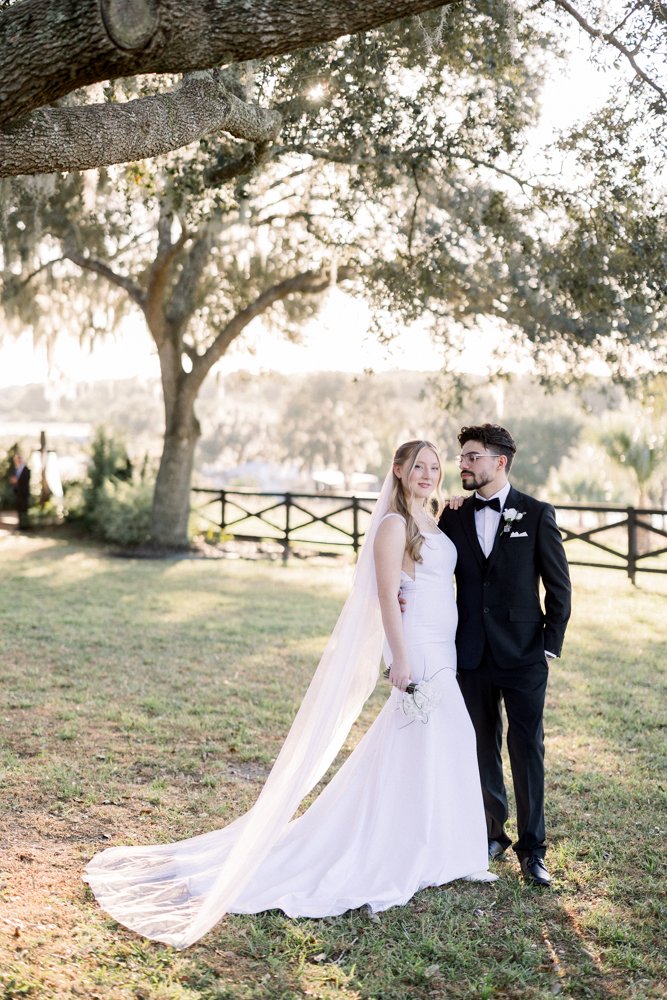 Bride and groom portrait under oak trees at Lakeview Gardens wedding venue in Umatilla, Florida