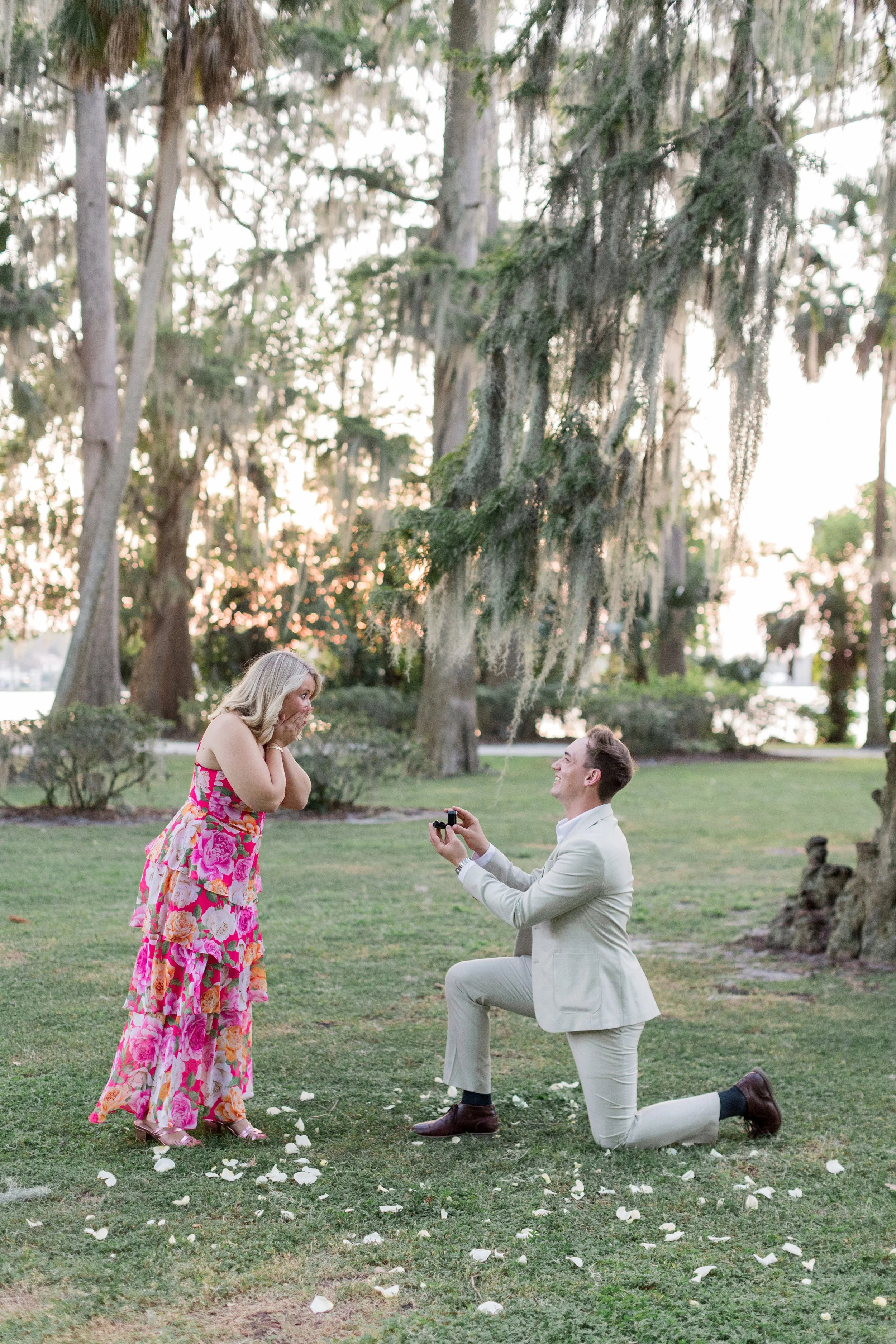 Man on one knee proposing under Spanish moss-covered oak trees, Central Florida proposal photographed by Created by Patty