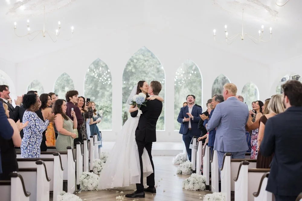 Guests watch the ceremony inside the white chapel at Whitewood Ranch in De Leon Springs, Florida