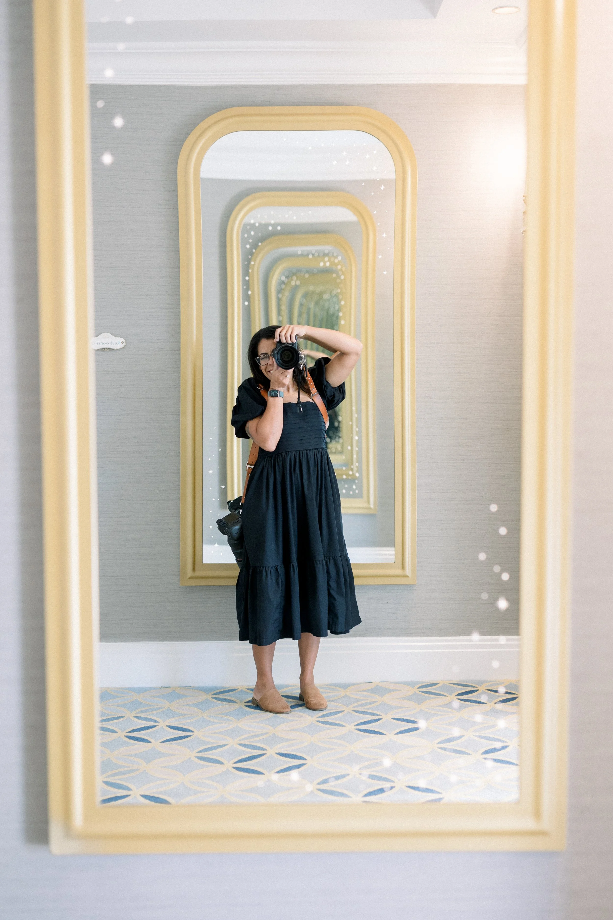 Central Florida wedding photographer Patty of Created by Patty with her camera in a gold mirror