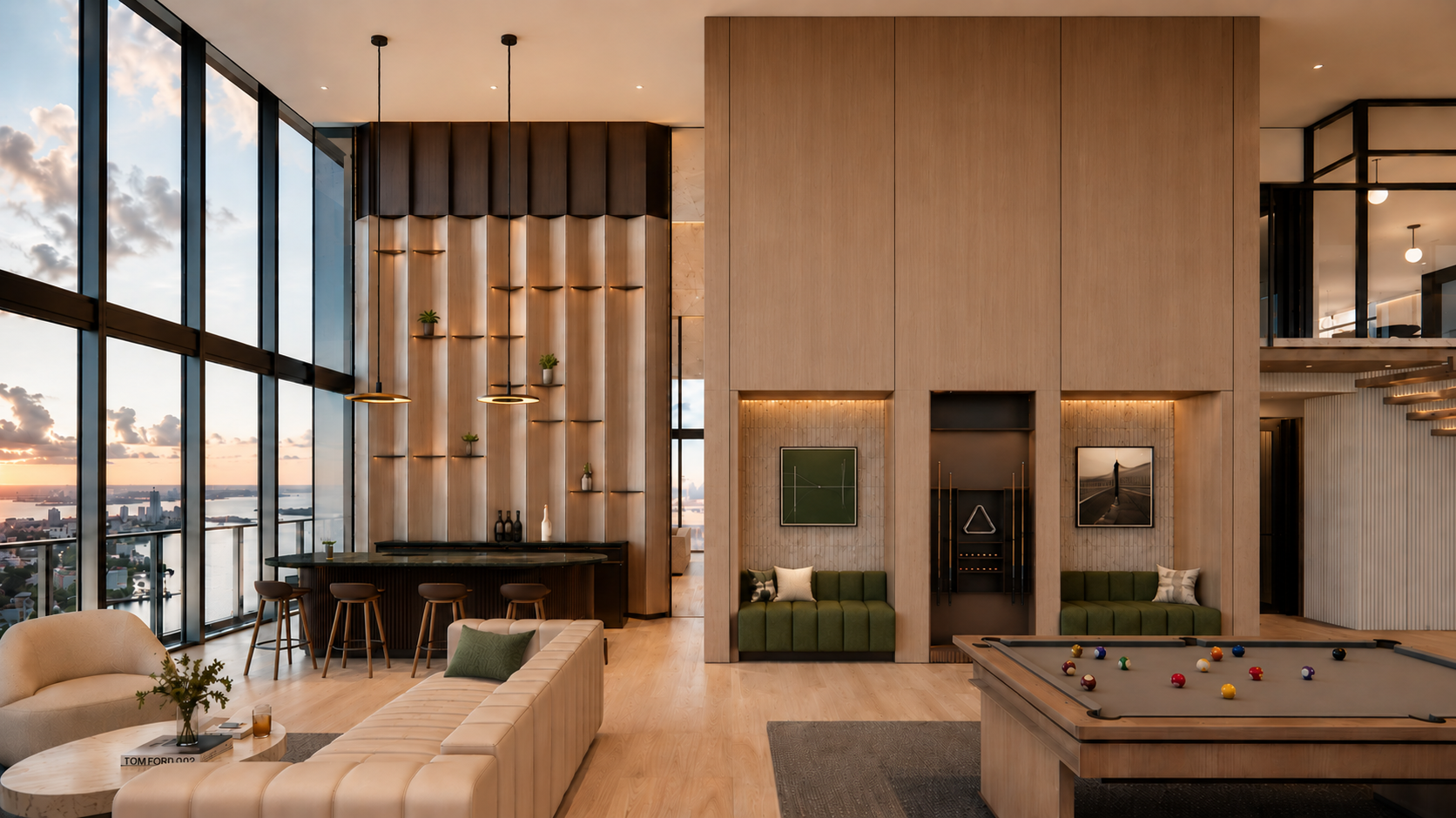 Interior of a modern high-rise lounge with large floor-to-ceiling windows showing a city and river view at sunset, featuring a pool table, green seating, wood accents, and minimalistic decor.