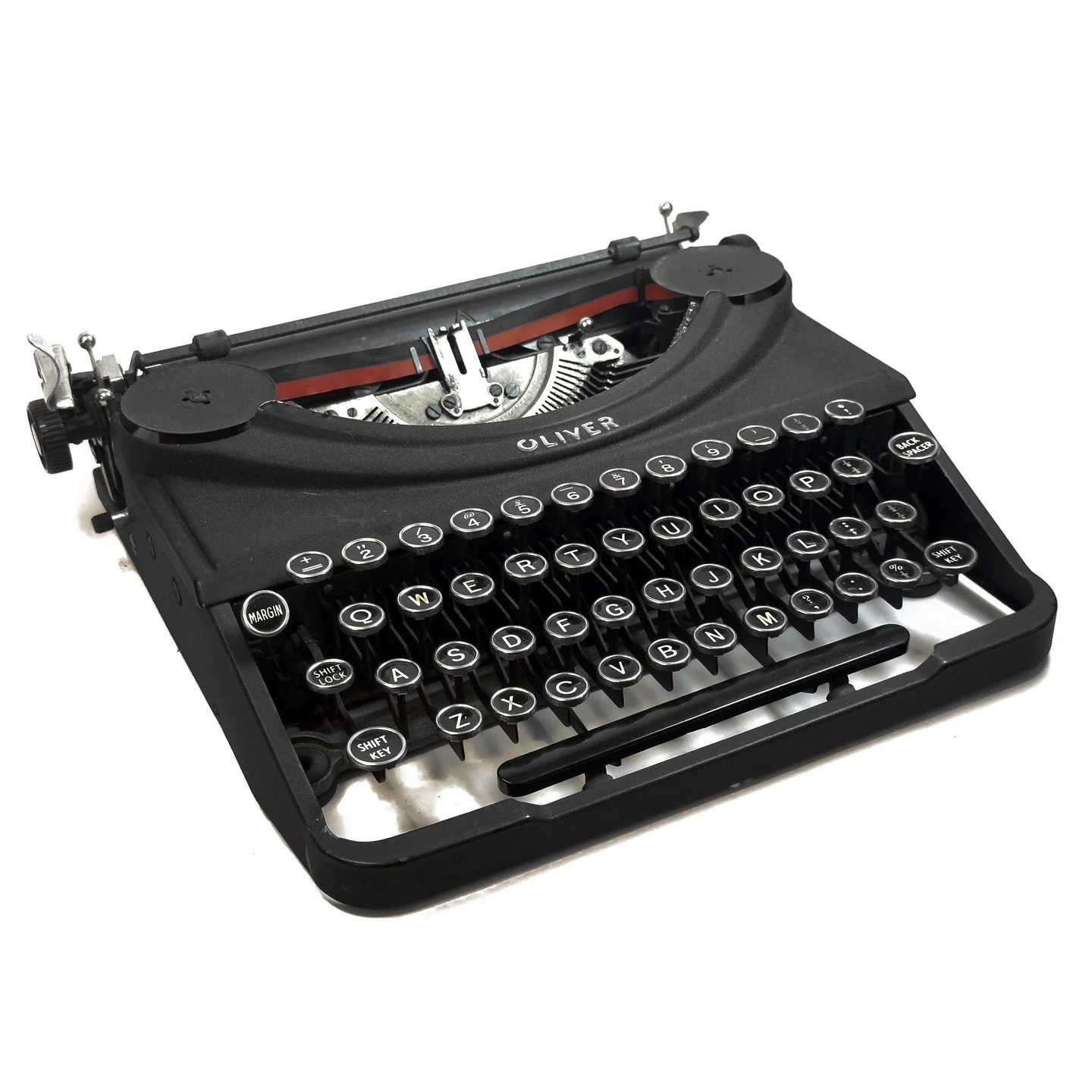 Recently added to the collection is this early Oliver Portable (Patria). Early examples like this feature ringed key tops, a painted OLIVER logo, a small paper table without a logo, and a branding decal on the back.