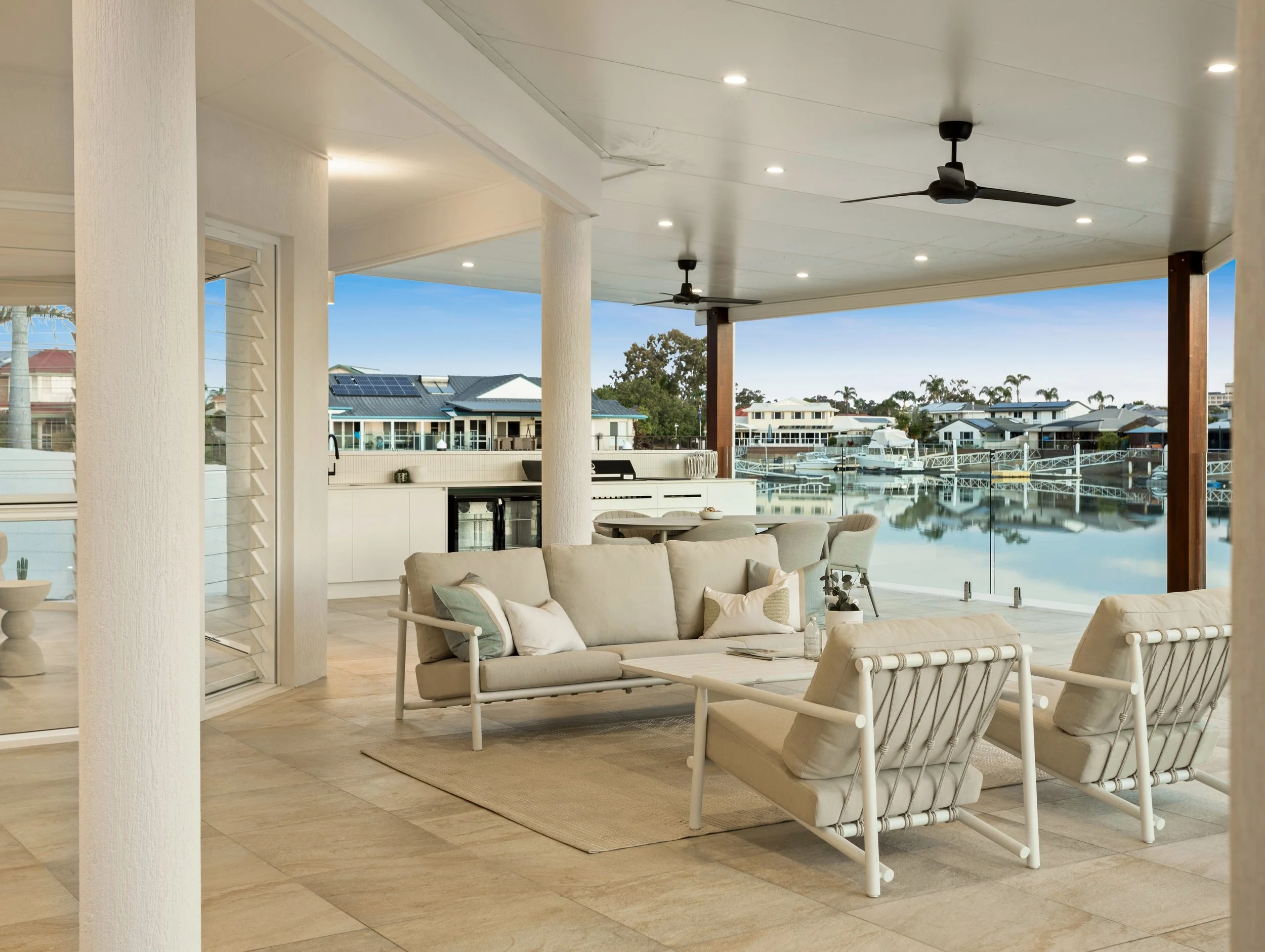 Outdoor luxury patio with modern furniture overlooking canals in Redcliffe, Brisbane.