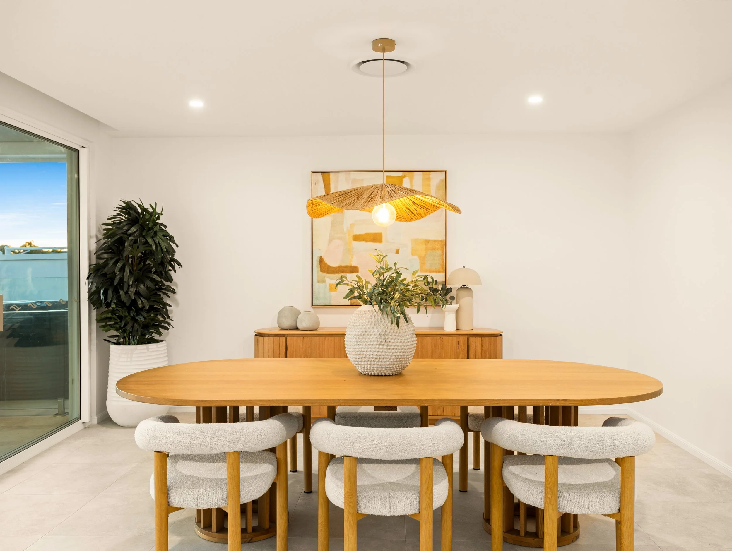 Luxury living room with modern lighting and wooden dining room in Brisbane City.