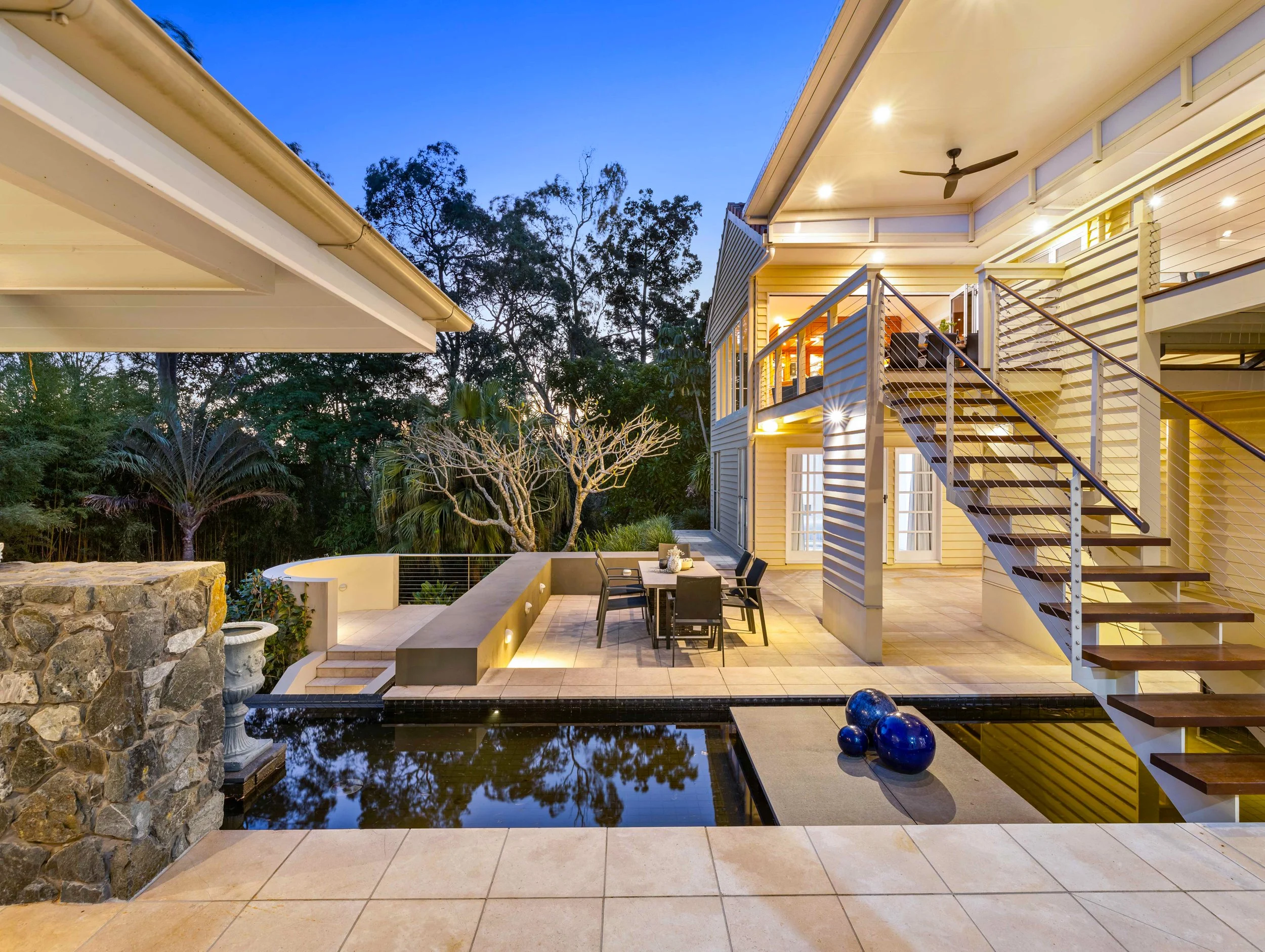 Dusk shot off a large historical house in Brisbane City with a large water feature.