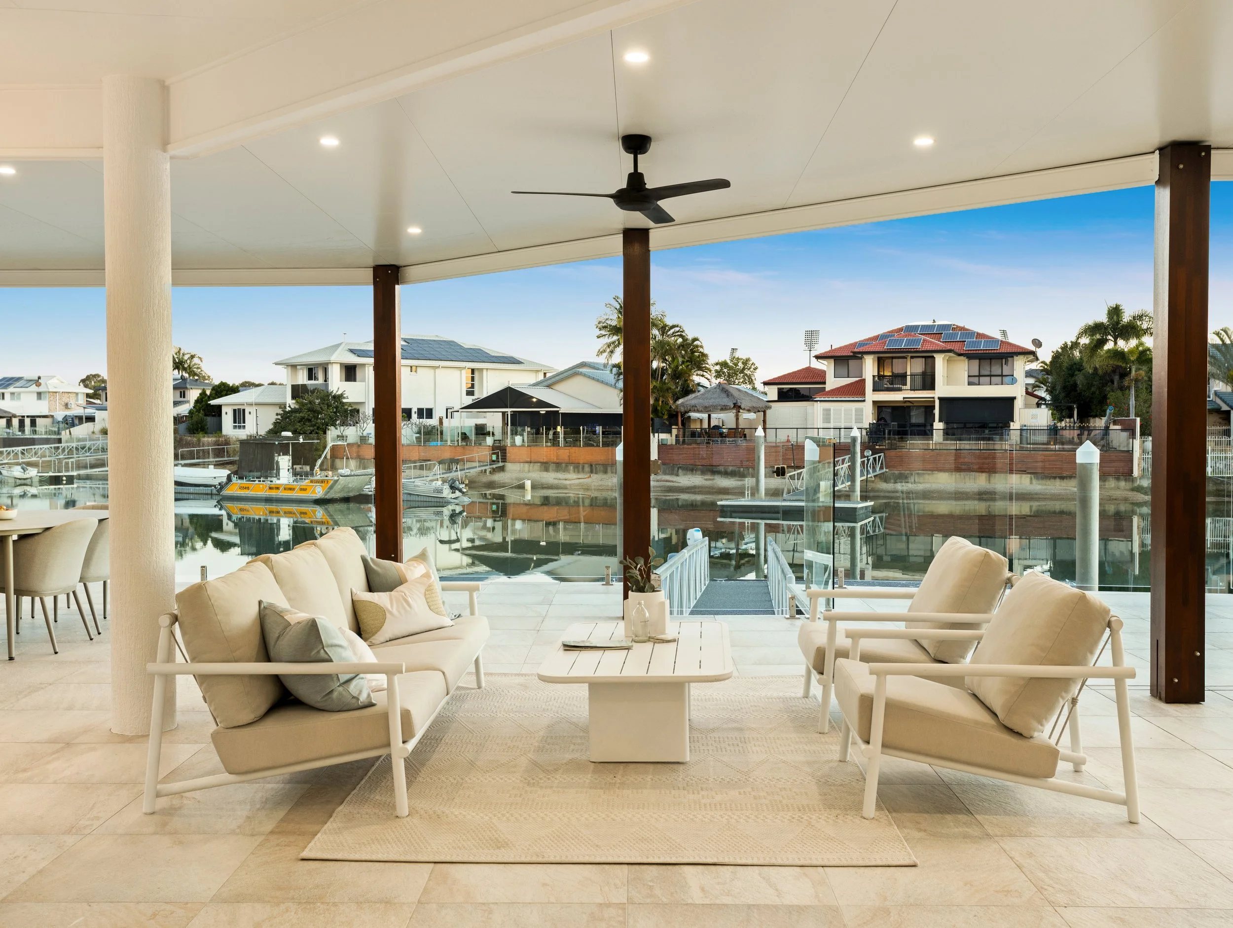 Outdoor patio with luxury furniture overlooking the canals of Redcliffe, Brisbane.