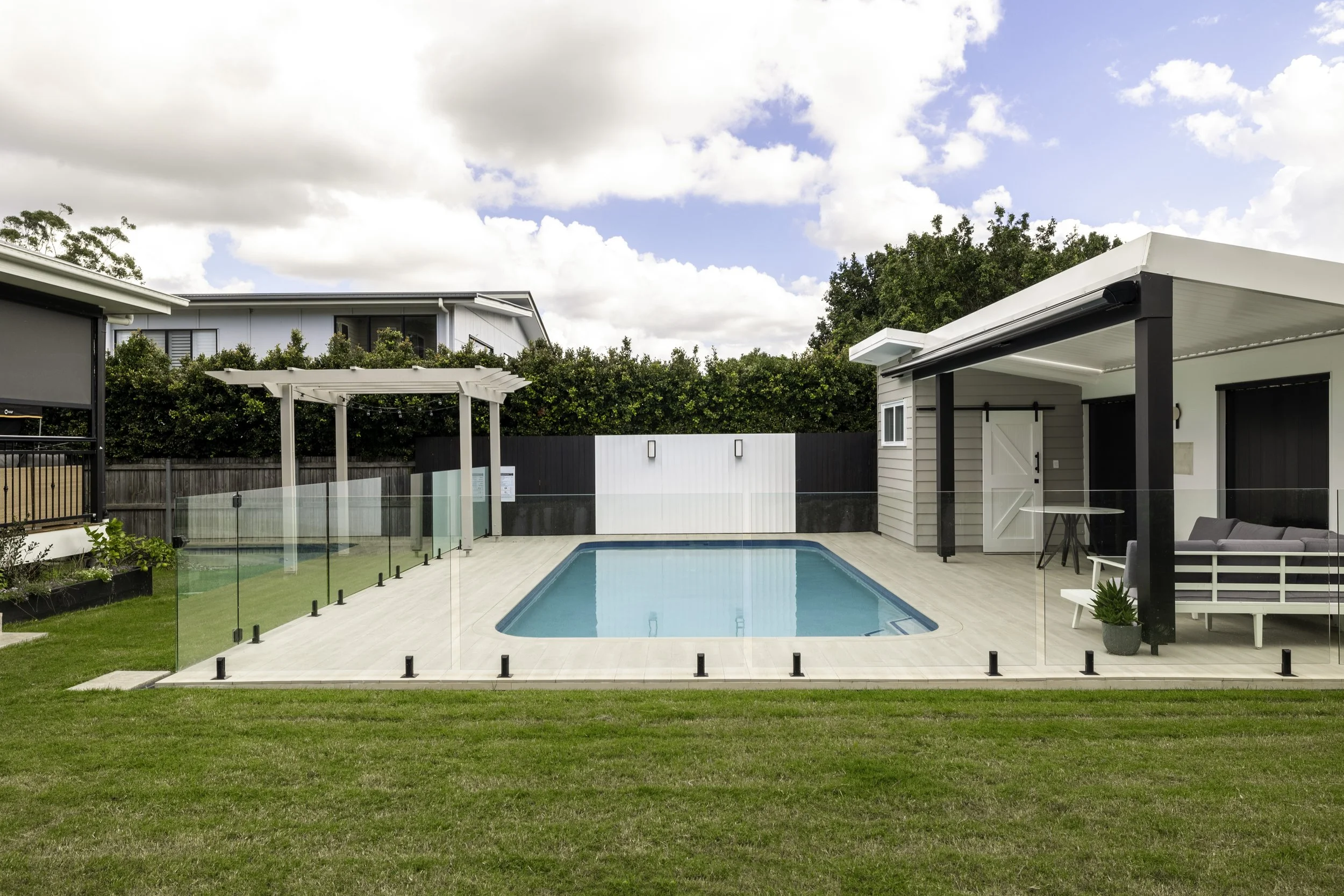 New pool house with large inbuilt pool shot on a sunny day located in Brisbane City.