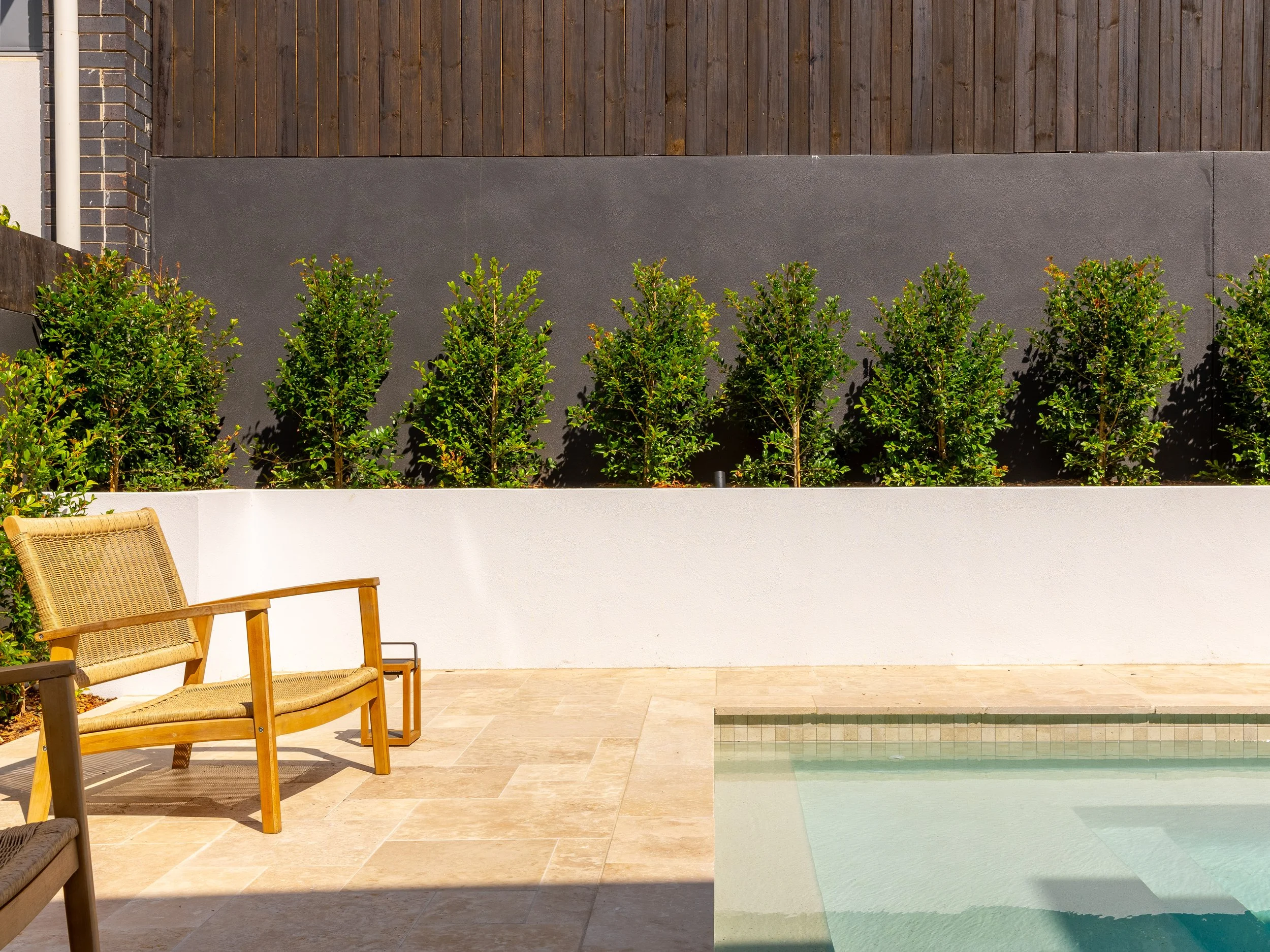 Textured tiling, with a large retainer wall and inbuilt pool located in Brisbane City.