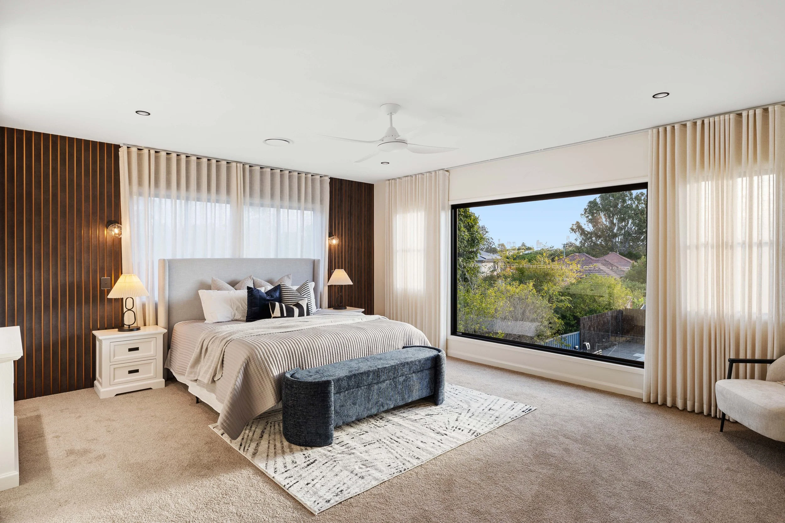 Luxury bedroom with luxury features and a large window overlooking Brisbane City.