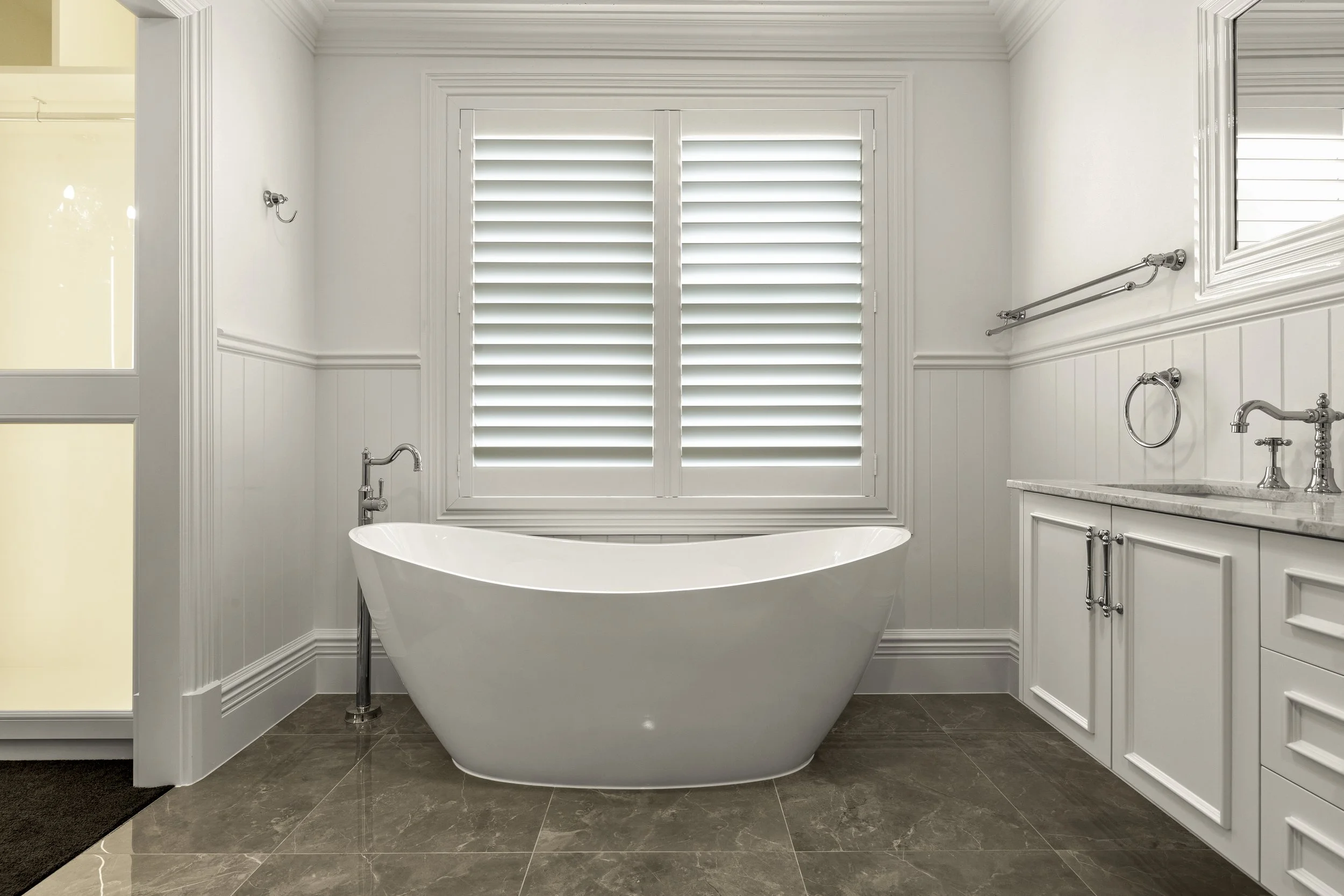 Hampton style bathroom with luxury fitting and a stand alone bath tub located in Brisbane City.