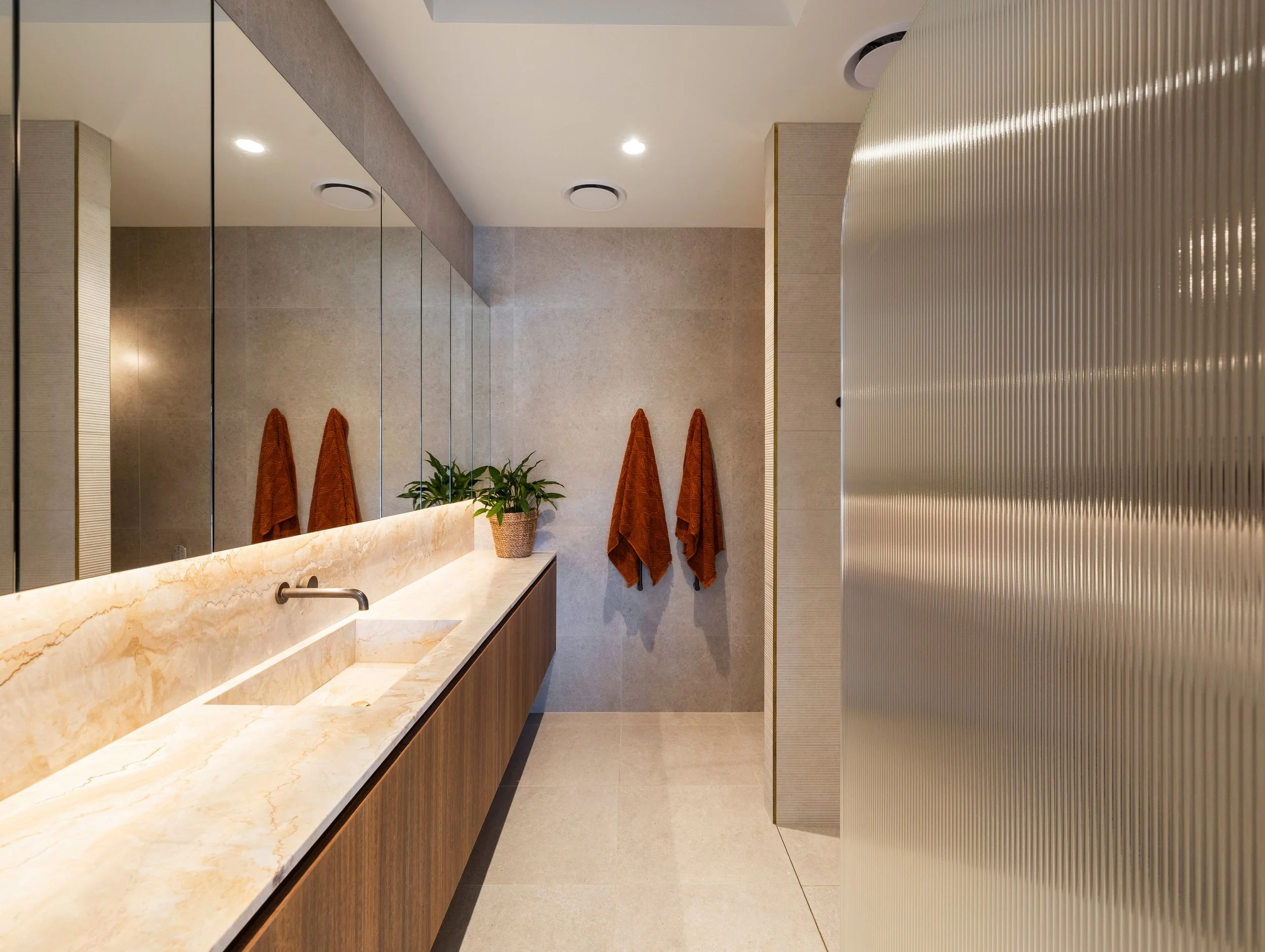 Luxury bathroom with unique stone and handmade fixtures located in Brisbane City. 