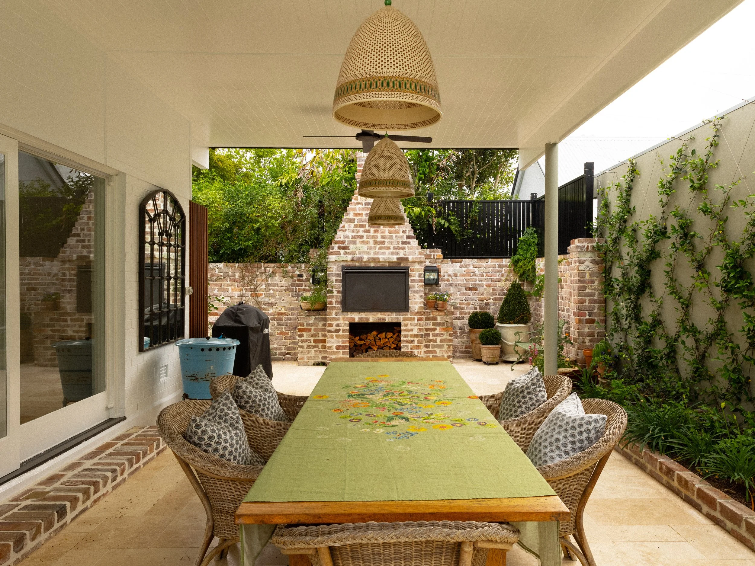 Luxury outdoor backyard with large pizza oven and lots of plants and vines located in Brisbane City.