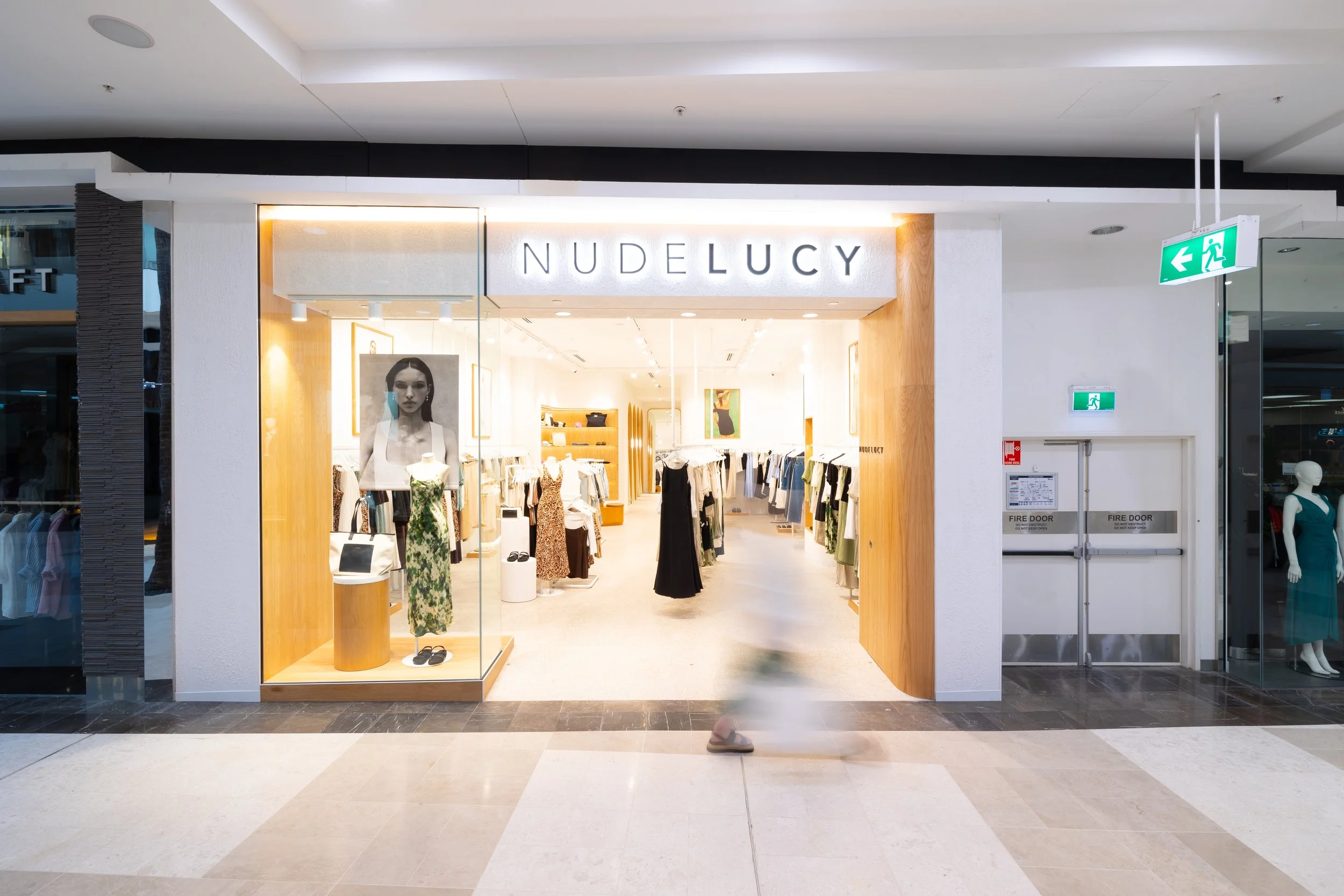 Nude Lucy Brisbane with shopper walking by Brisbane City.