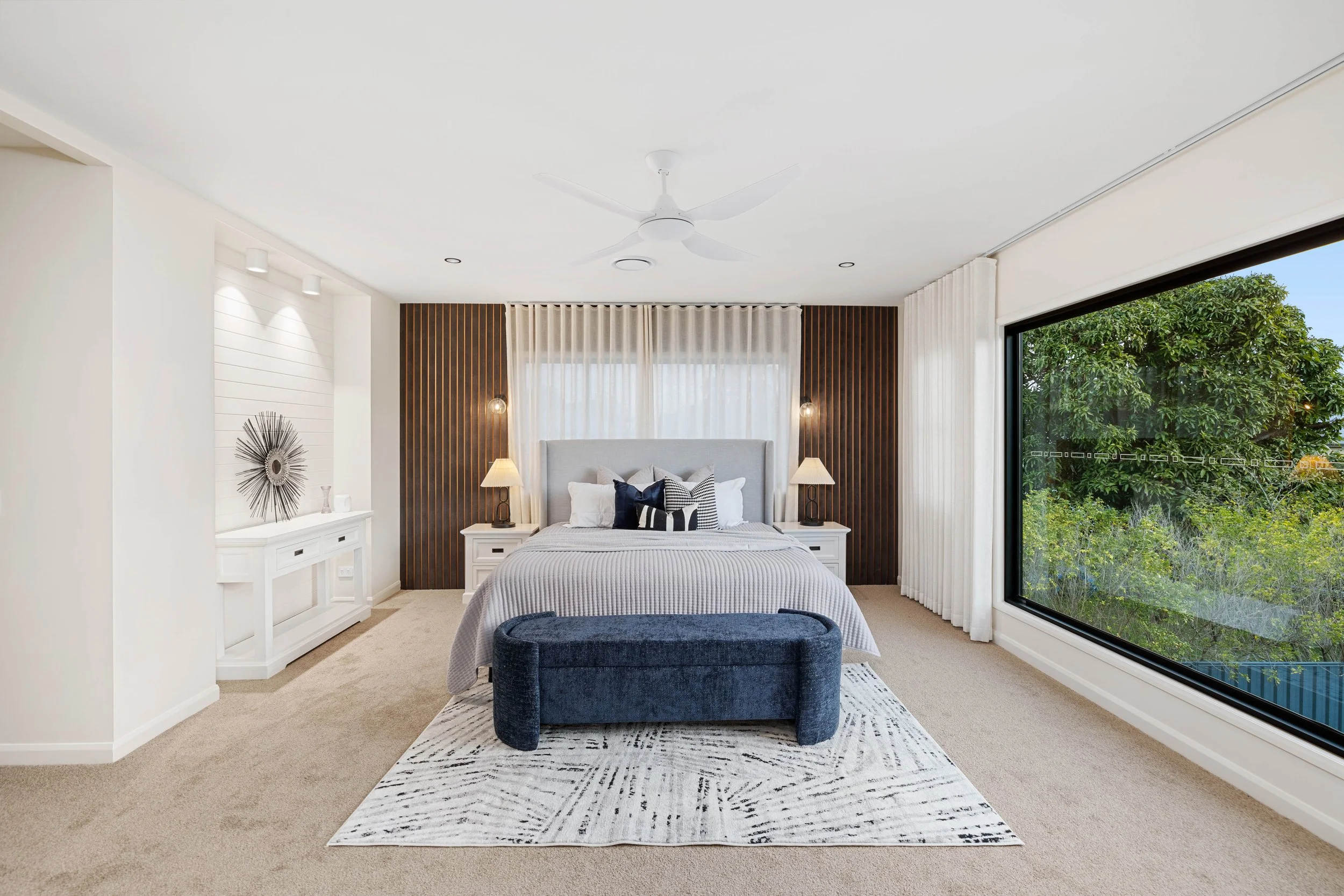 Large luxury bedroom with a large window overlooking Brisbane City in Morningside. 