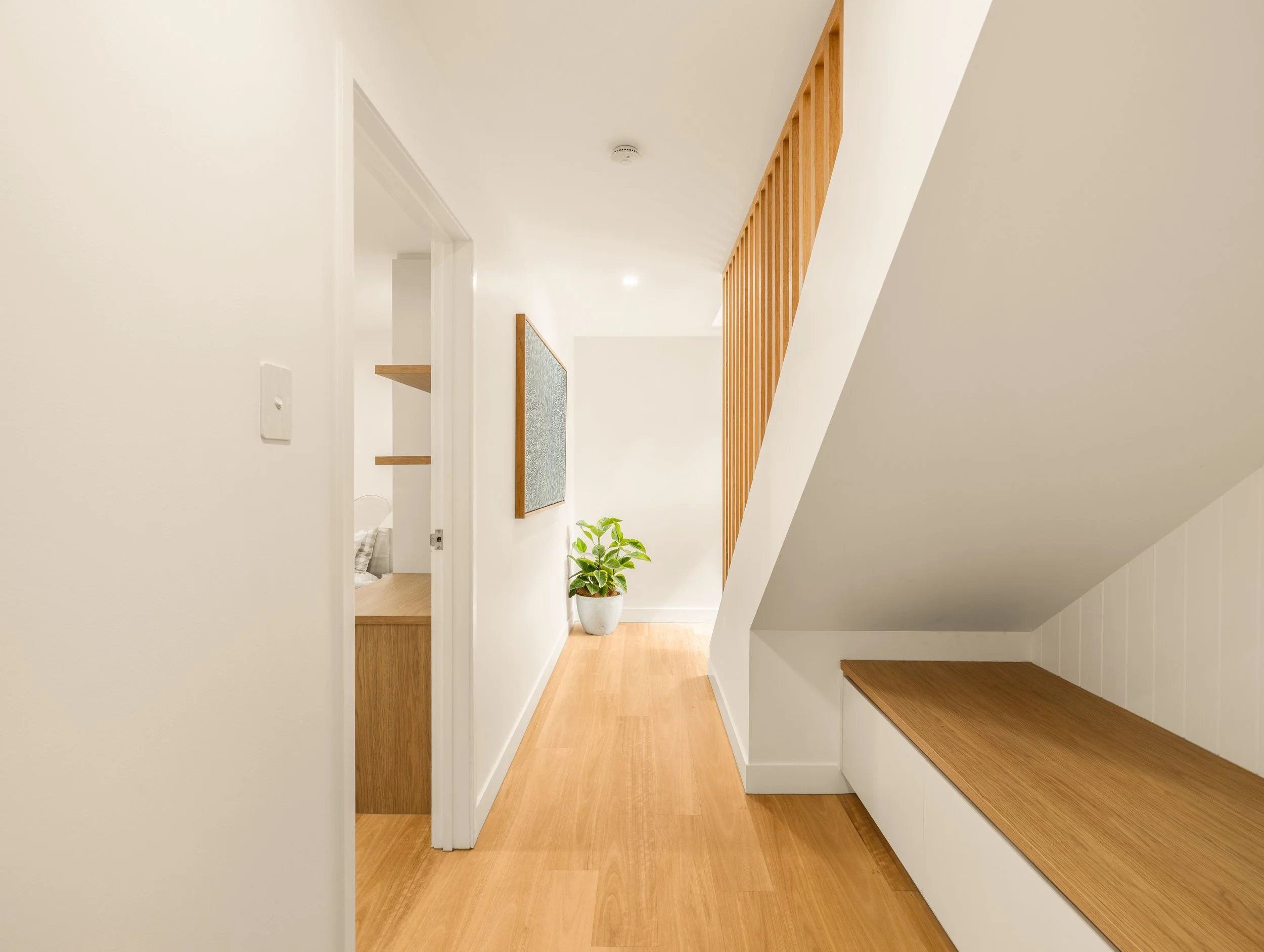 Unique hallway with soft tones and wooden flooring located in Brisbane City.