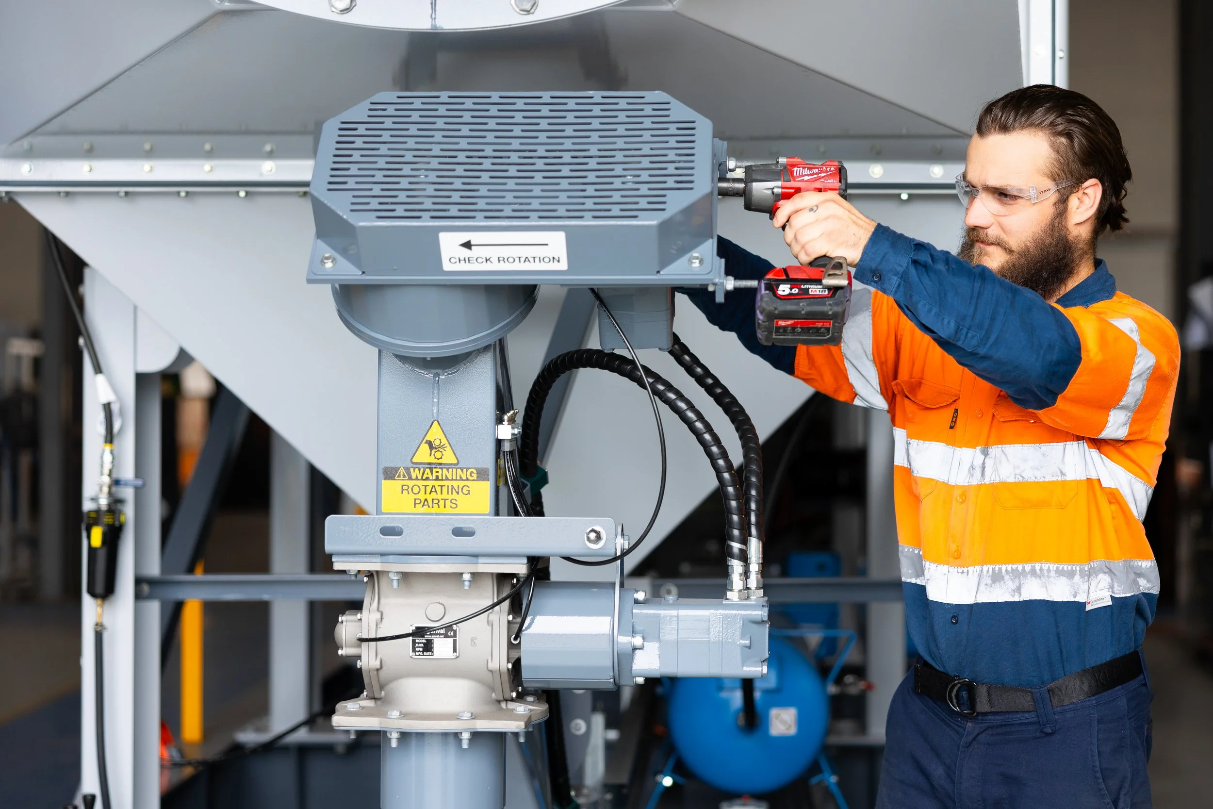 Grydale assembly hand screwing in filter cover products to unit Brisbane.