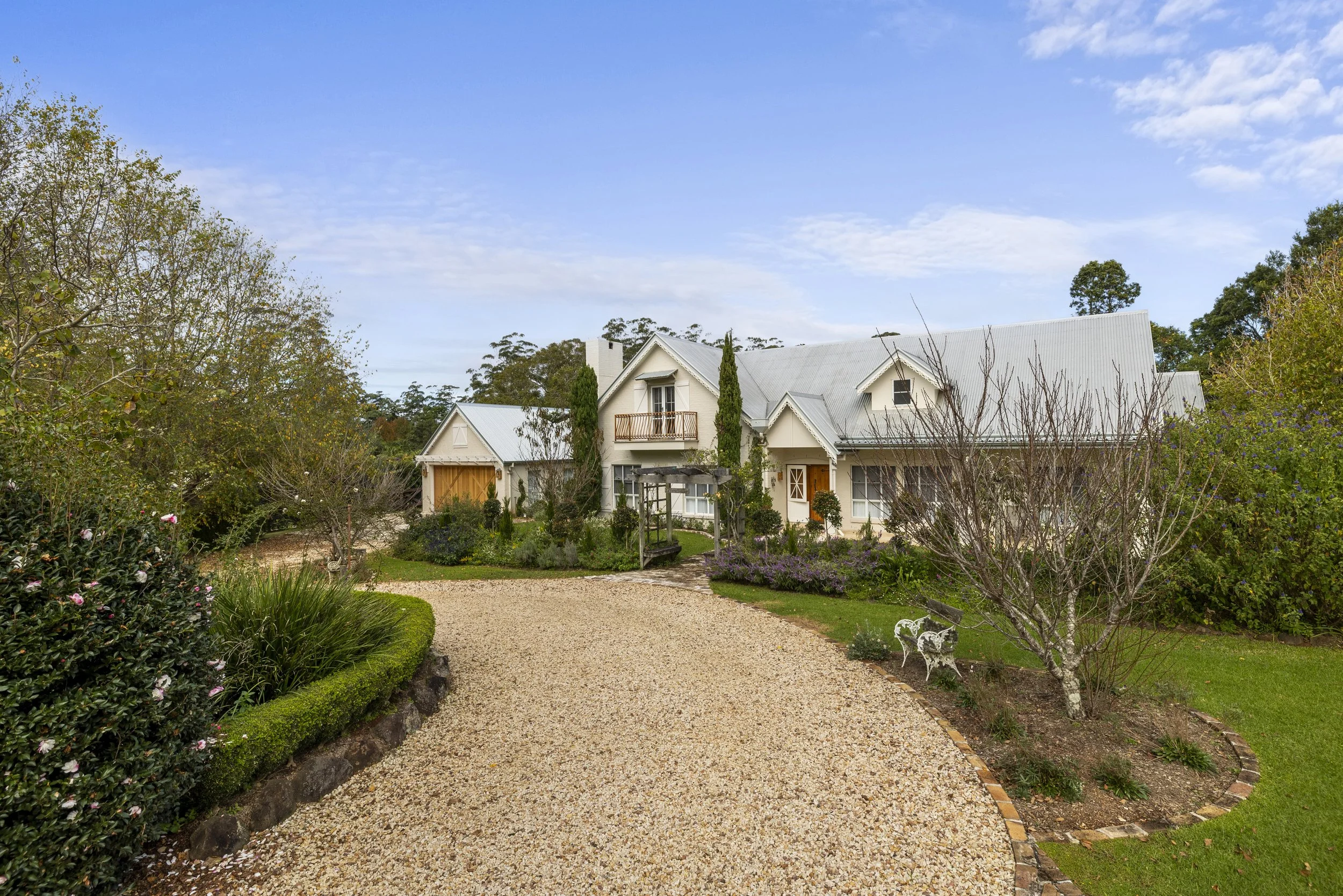 Gold coast property with lots of trees and large driveway, european styled.