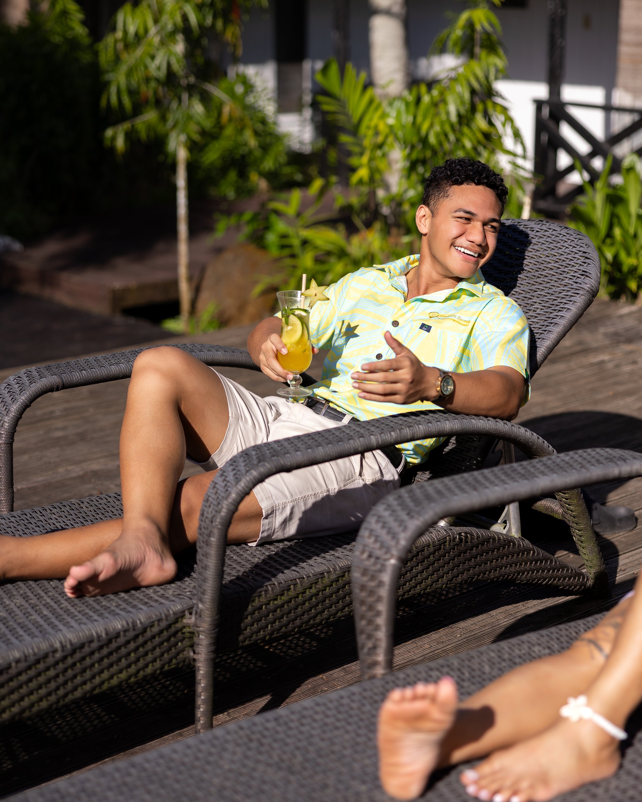 Male enjoying drinks poolside at Orator Hotel Samoa.