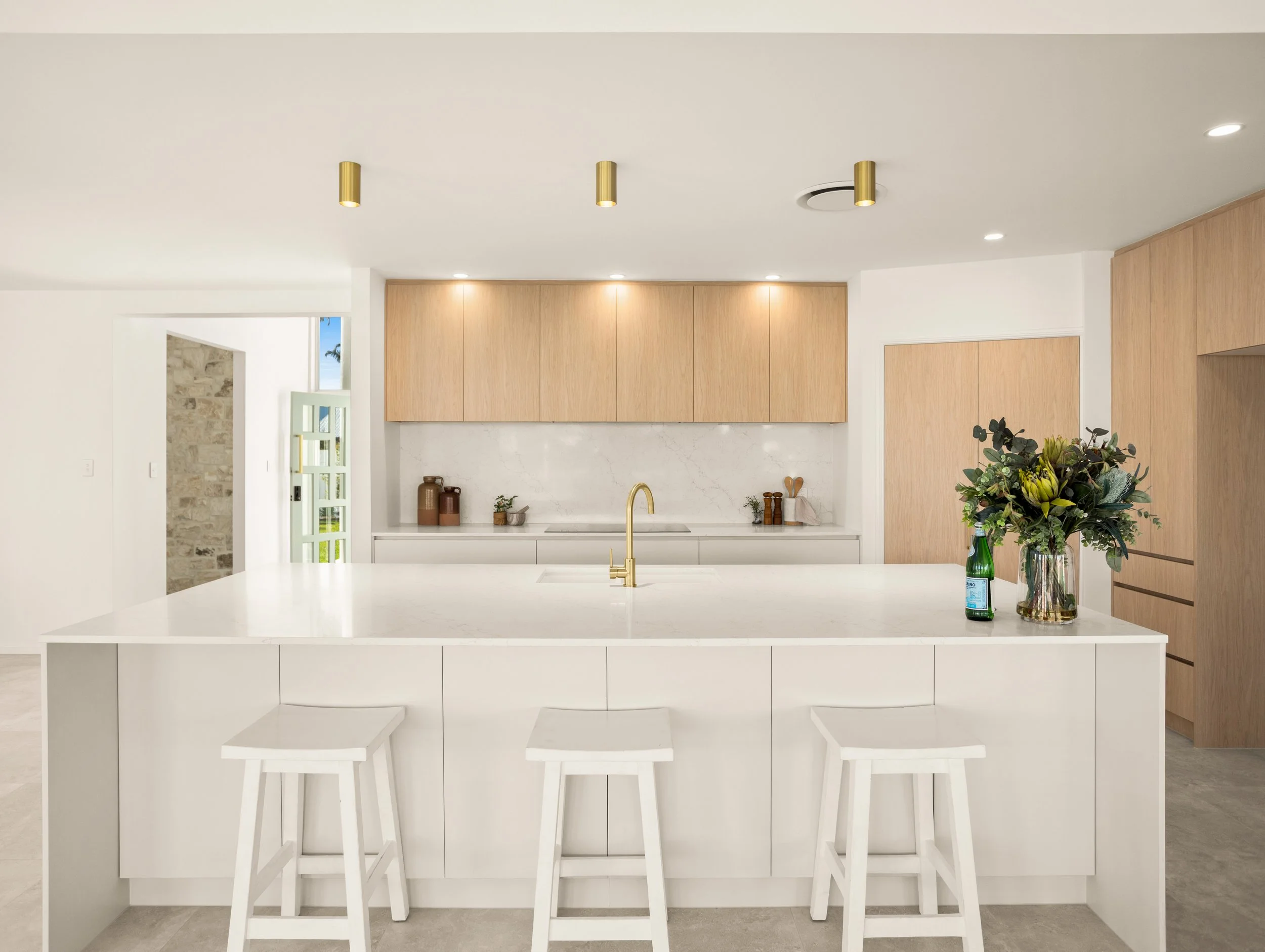 Soft toned kitchen in Redcliffe, Brisbane overlooking the canal with modern fitting and fixtures.