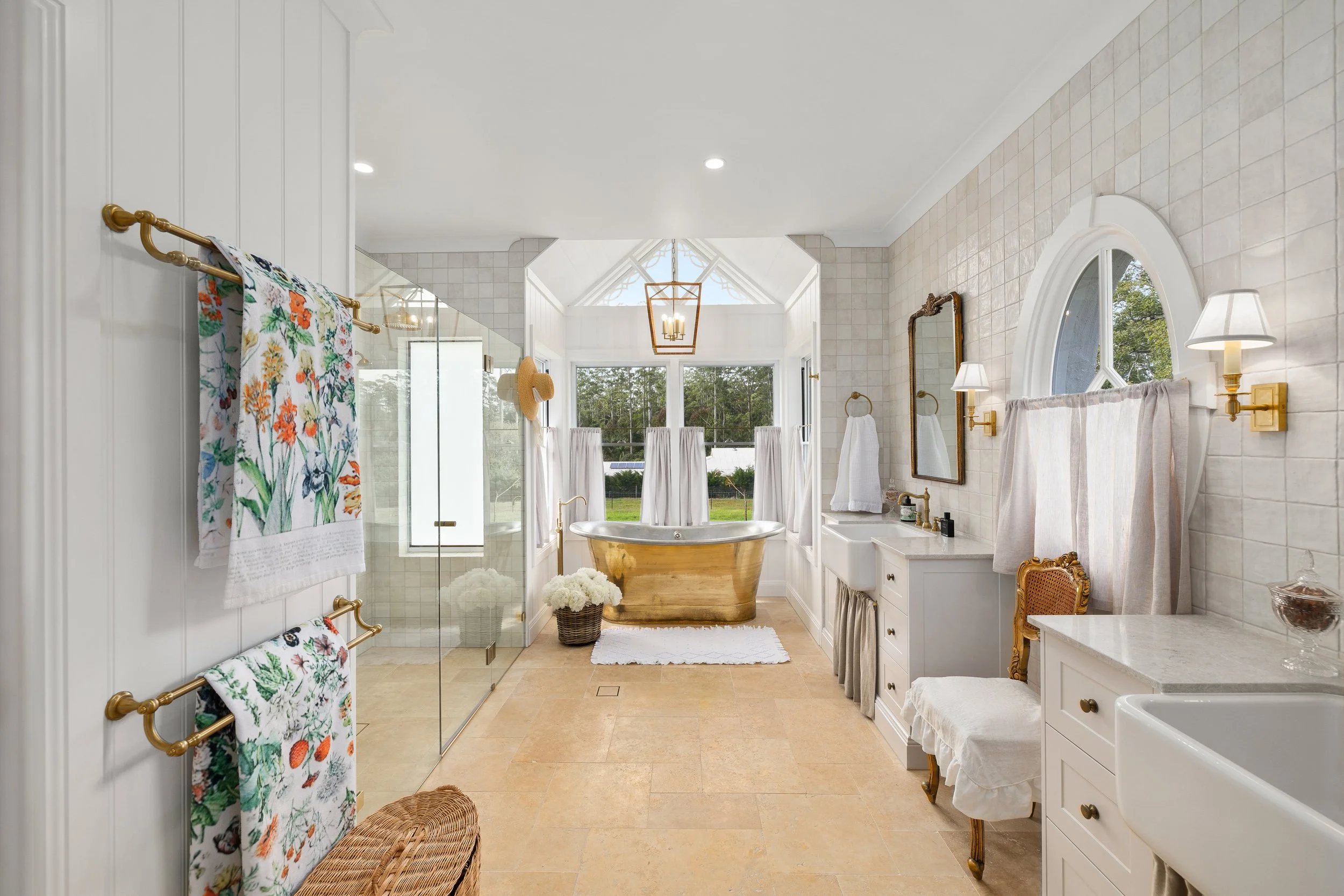 Luxury bathroom with european styled features and a large gold stand alone bath tub in Gold Coast.