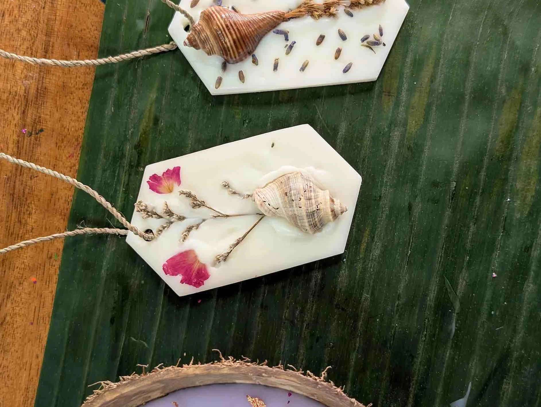 Person painting a glowing solar system scene under blacklight.