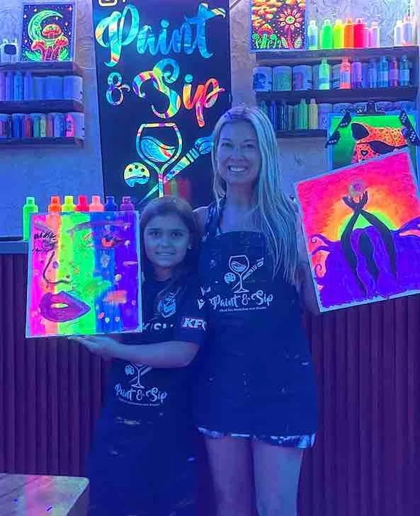 a parent painting with his two girls