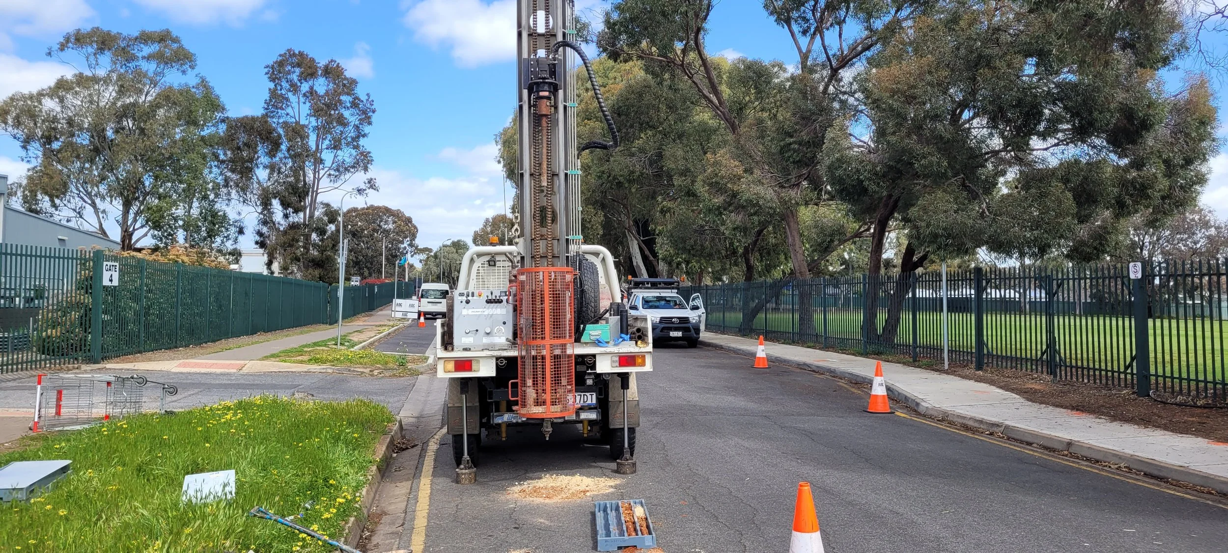 geotechnical drilling rig/truck performing soil investigation work on a road site.