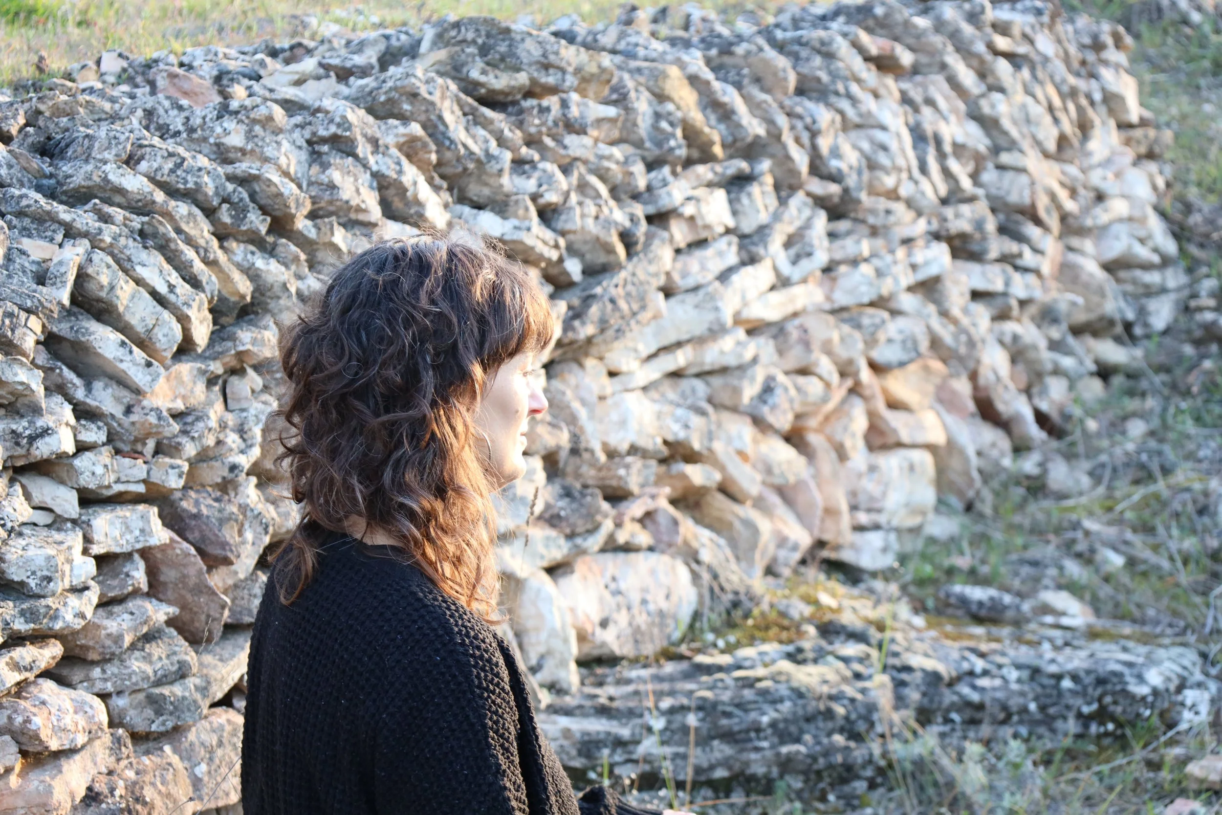 Chloë FitzGerald head and shoulder shot against dry stone wall