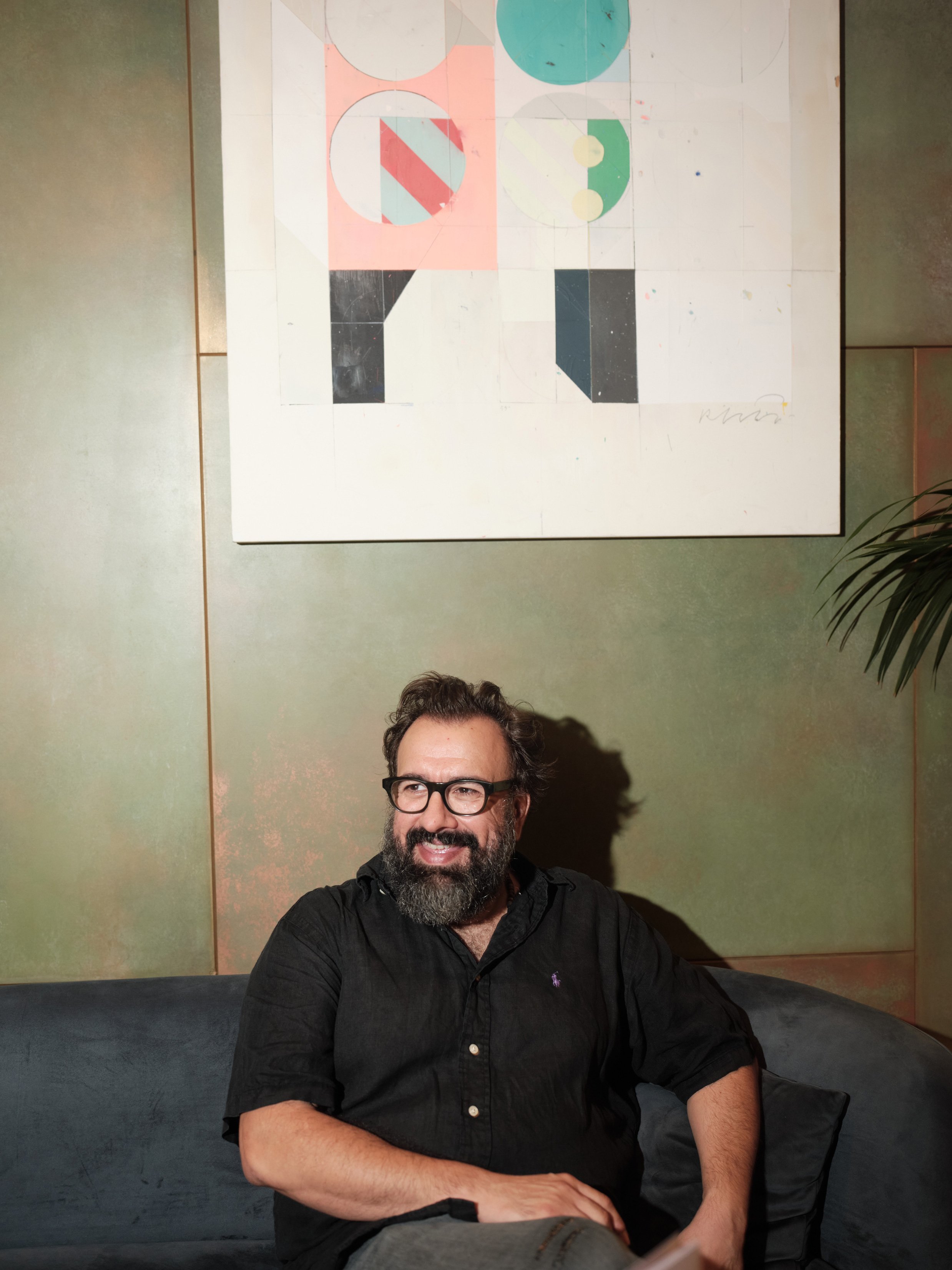 Painting by Alberto Ruiz Villar installed above seating during a hospitality art collaboration in Barcelona.