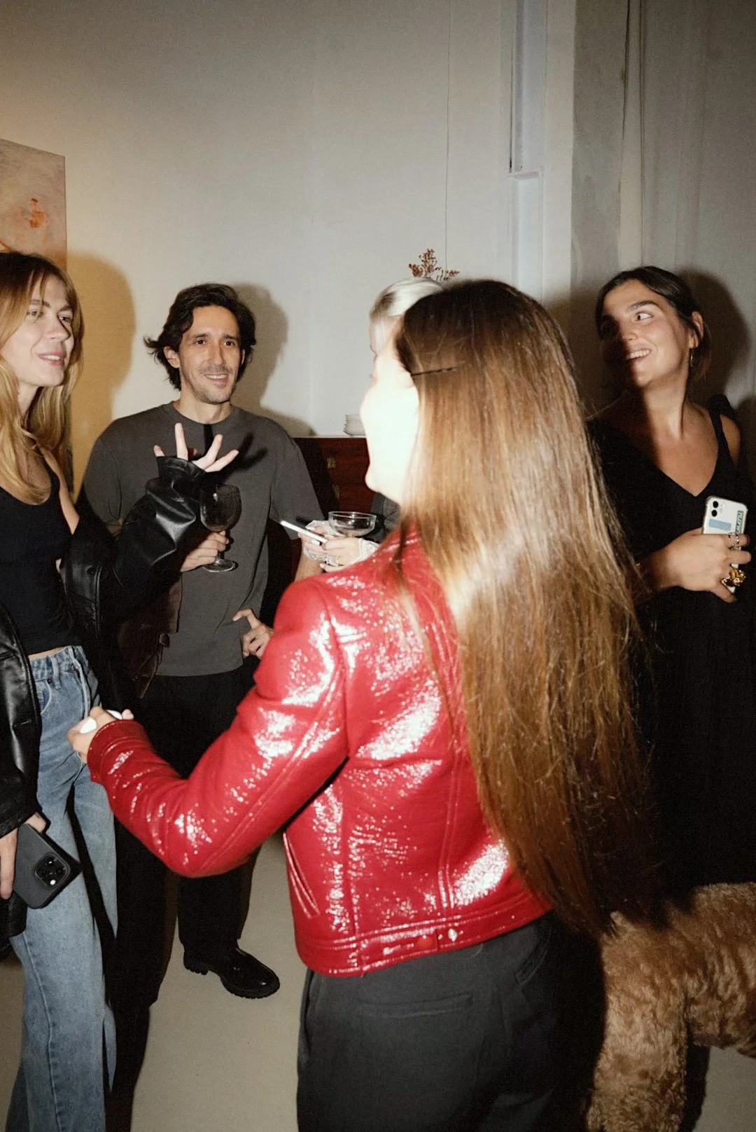 Visitors in conversation during the Among Us exhibition opening at Matiz Gallery in Barcelona.