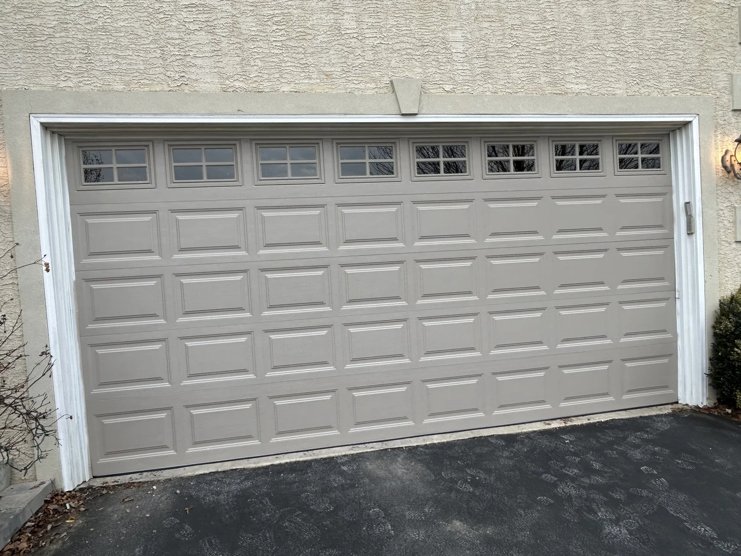 Garage door with rectangular windows on a house exterior