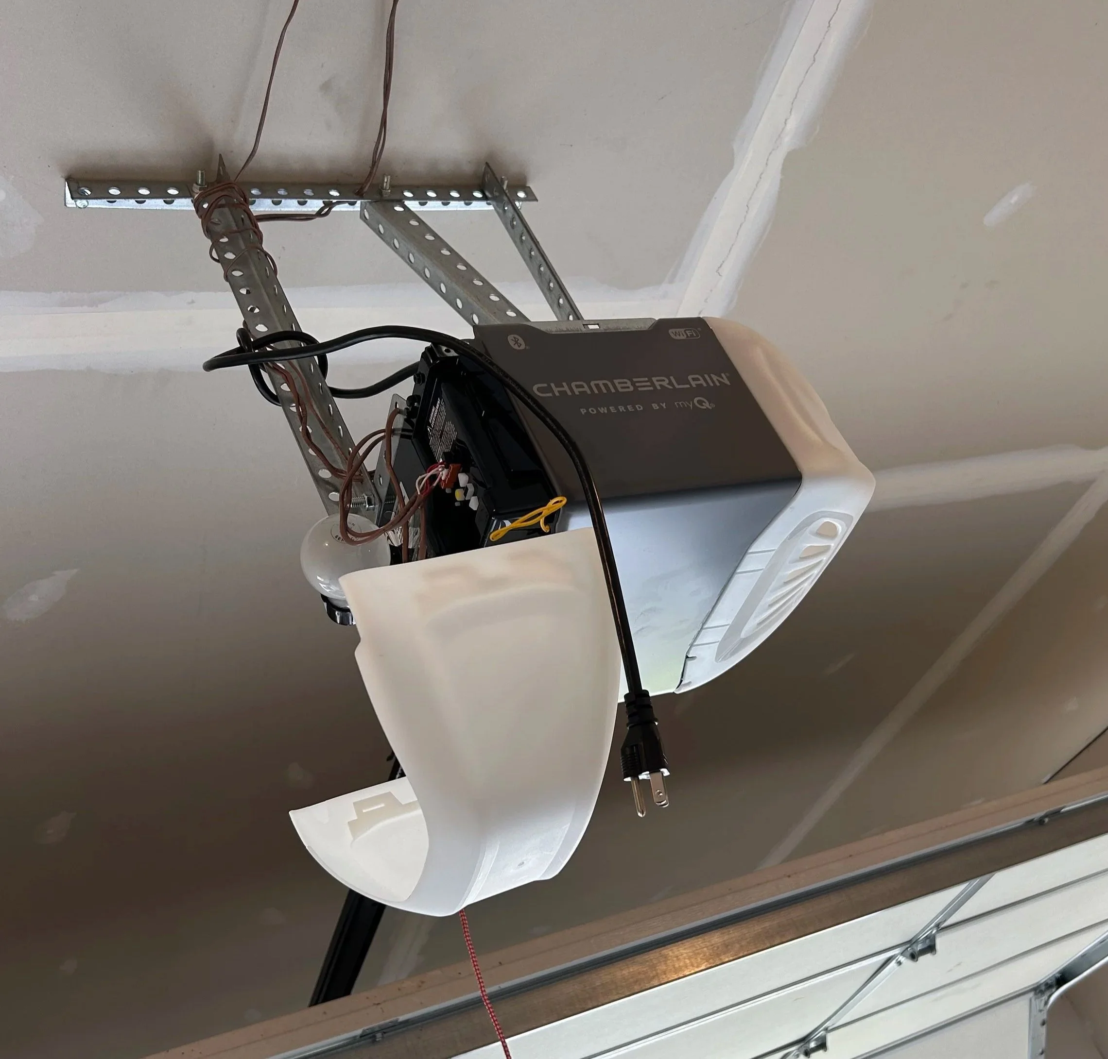 Chamberlain garage door opener mounted on a garage ceiling