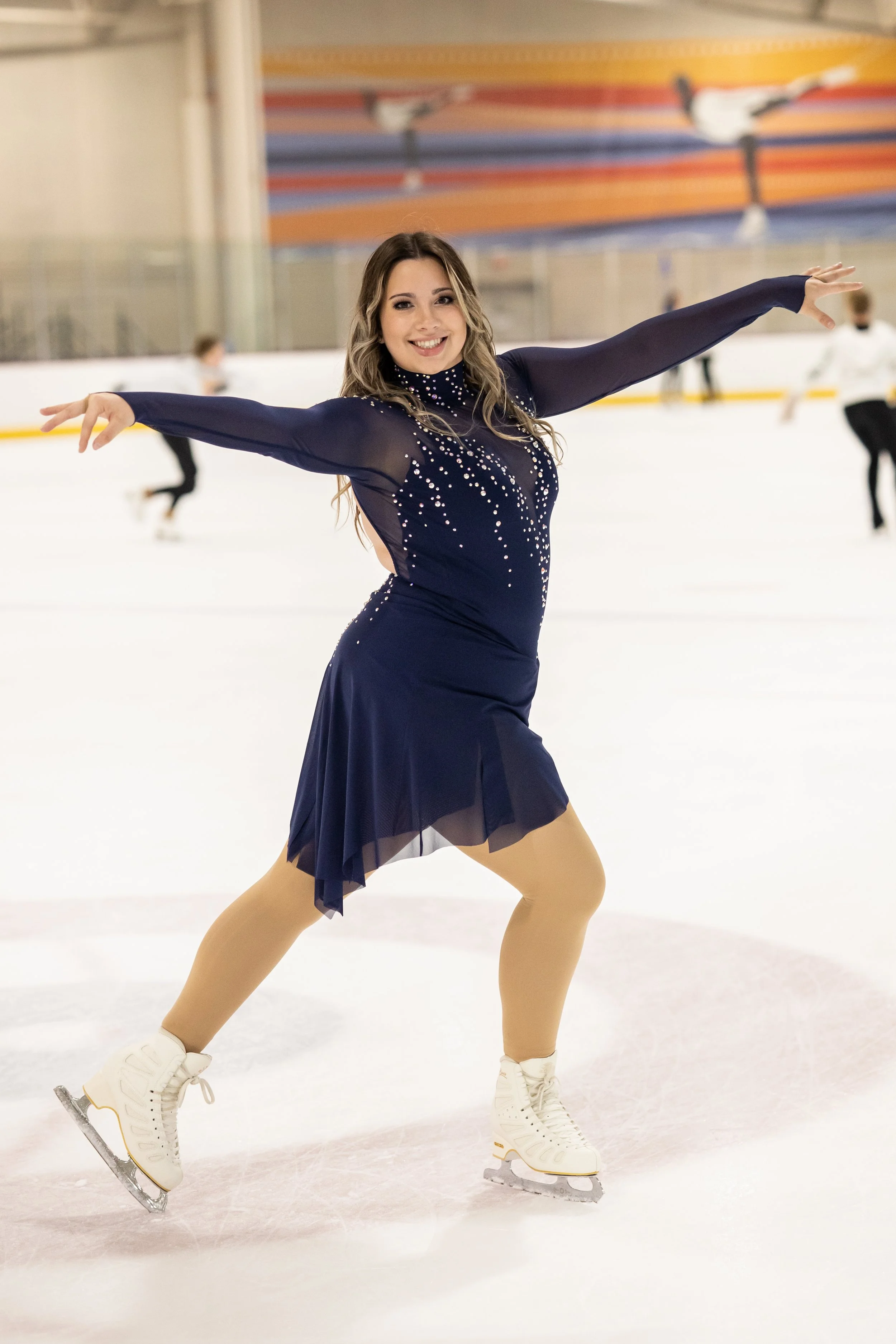Figure skating coach dressed in a competition dress on the ice
