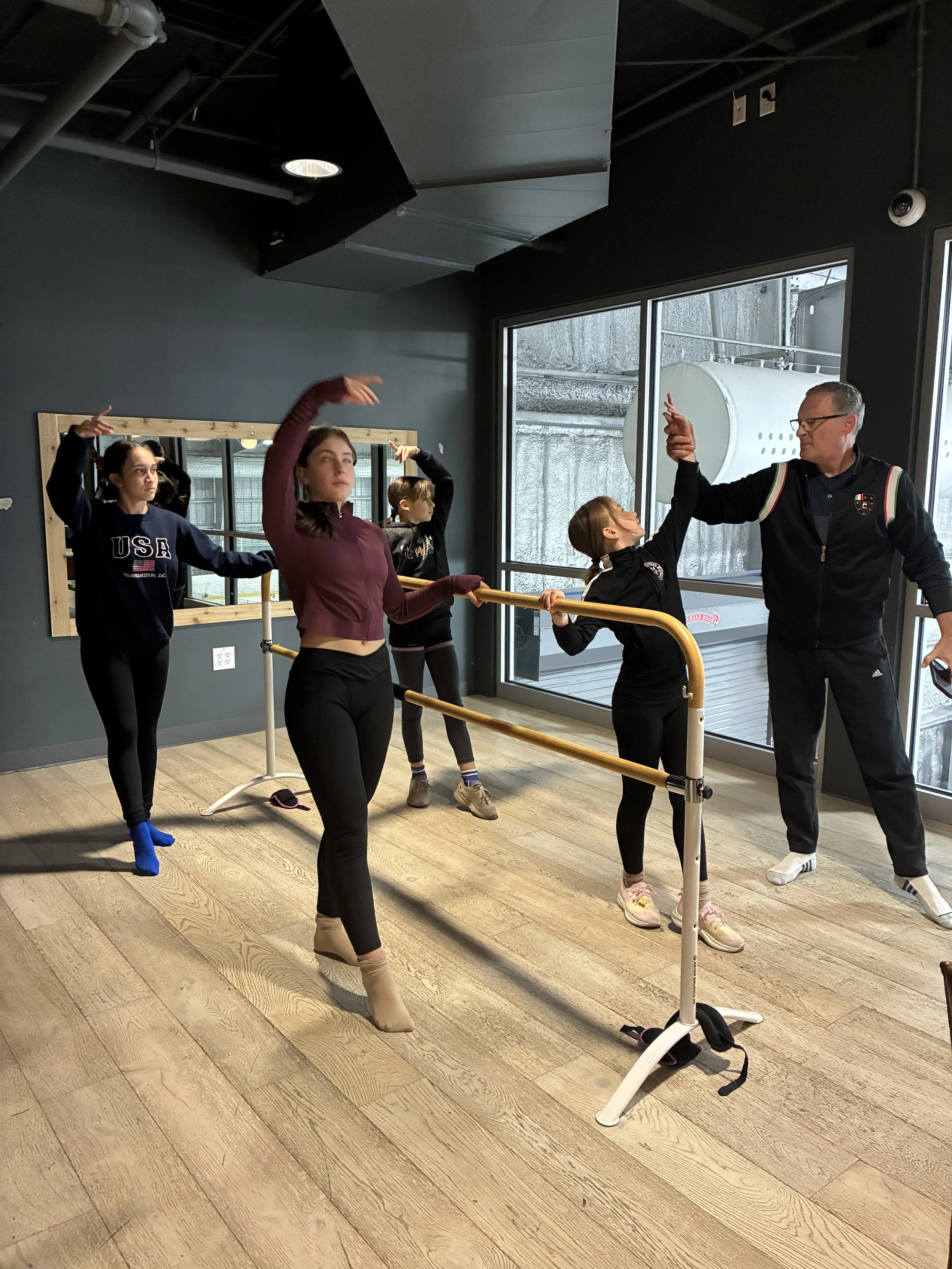 Student in class practicing ballet at the barre
