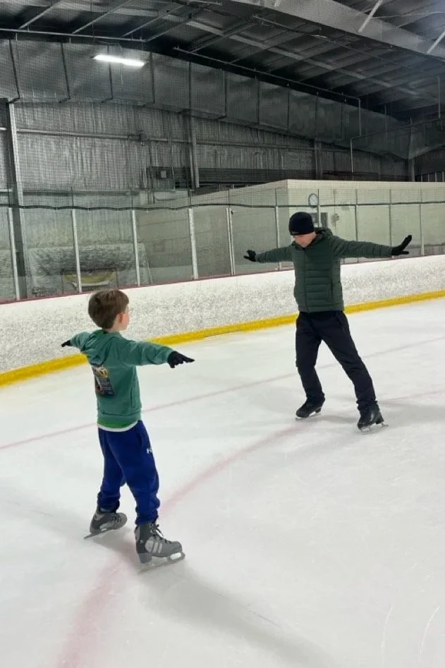 Coach and skater in a private ice skating lesson at Skate VIDA in Austin, TX