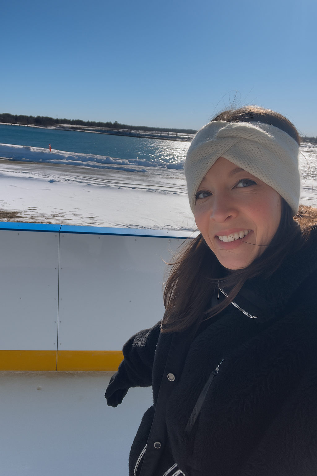 Coach Kymberlie posing on a boat with the ocean in the background
