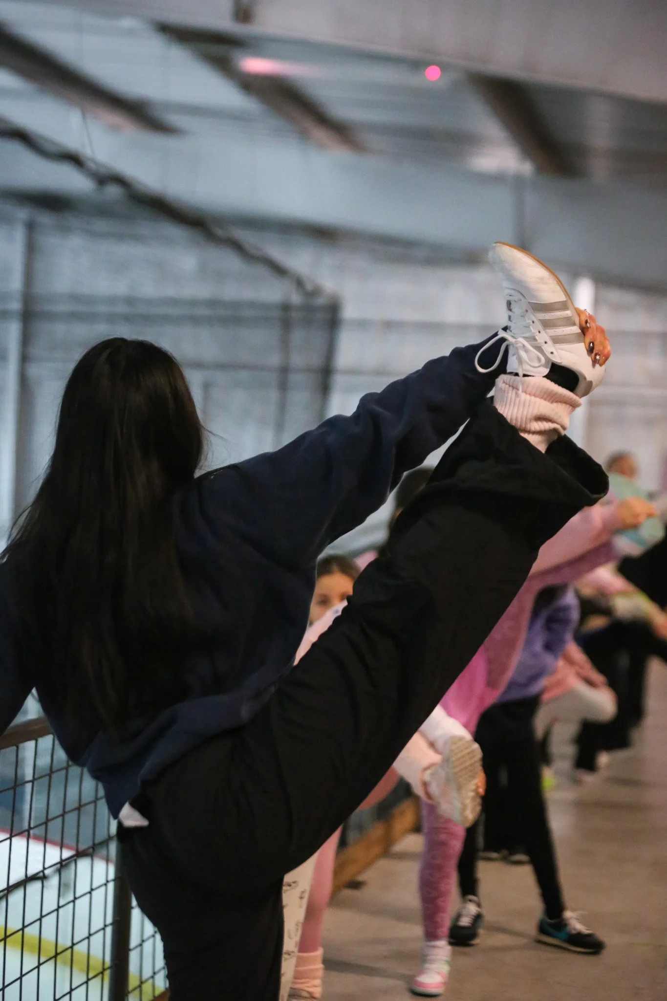 Skaters stretching during off ice class at figure skating camp in Austin at Skate VIDA