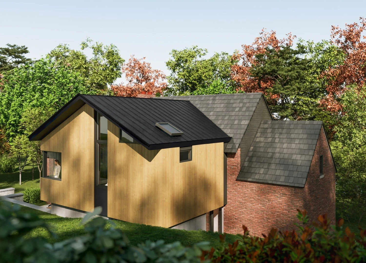 A modern two-story house with a black metal roof, light wood siding on the front, and brick walls on the side, surrounded by green trees and grass.
