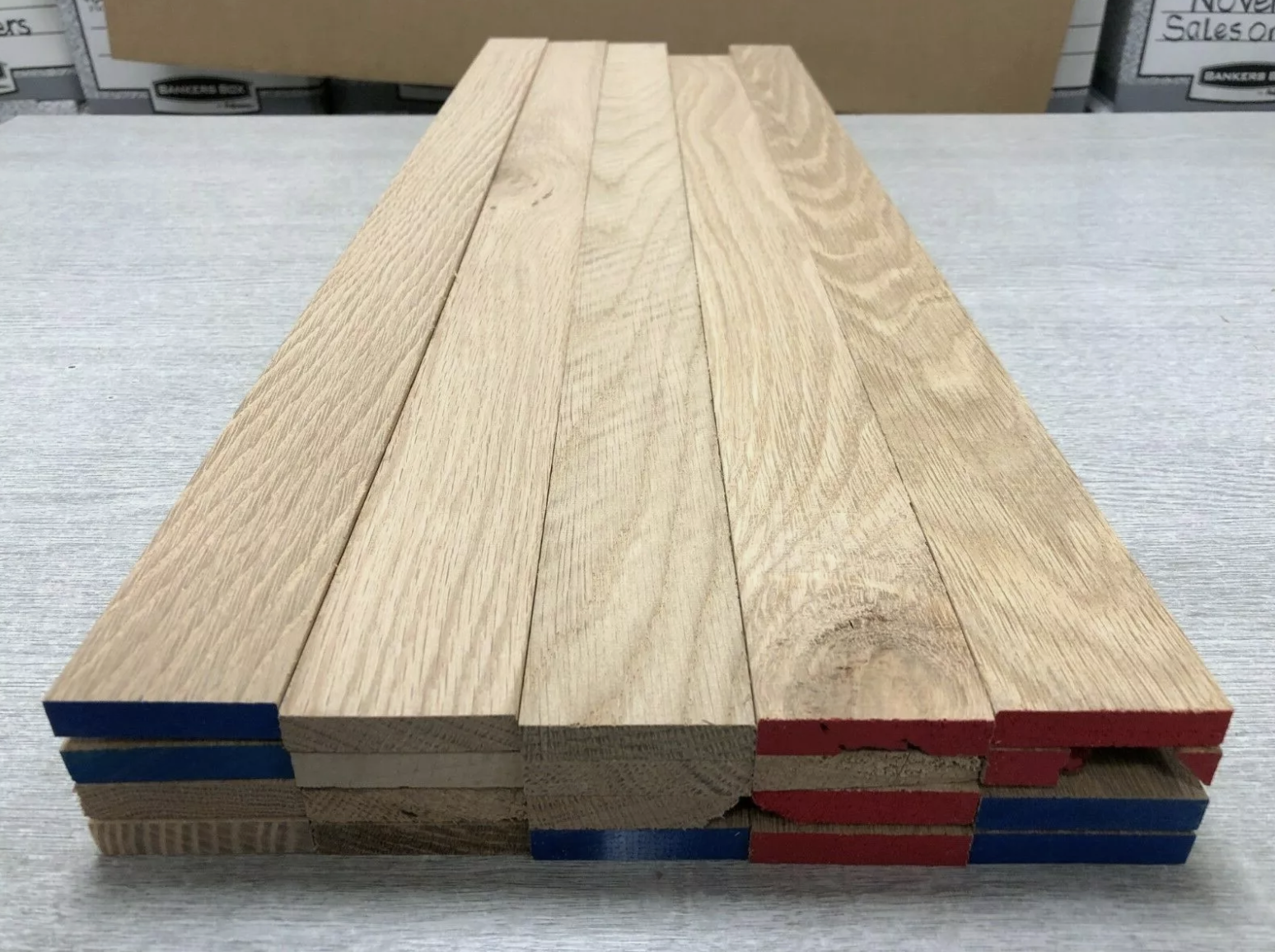 Smooth planed oak boards showing natural grain and warm tone, ready for joinery