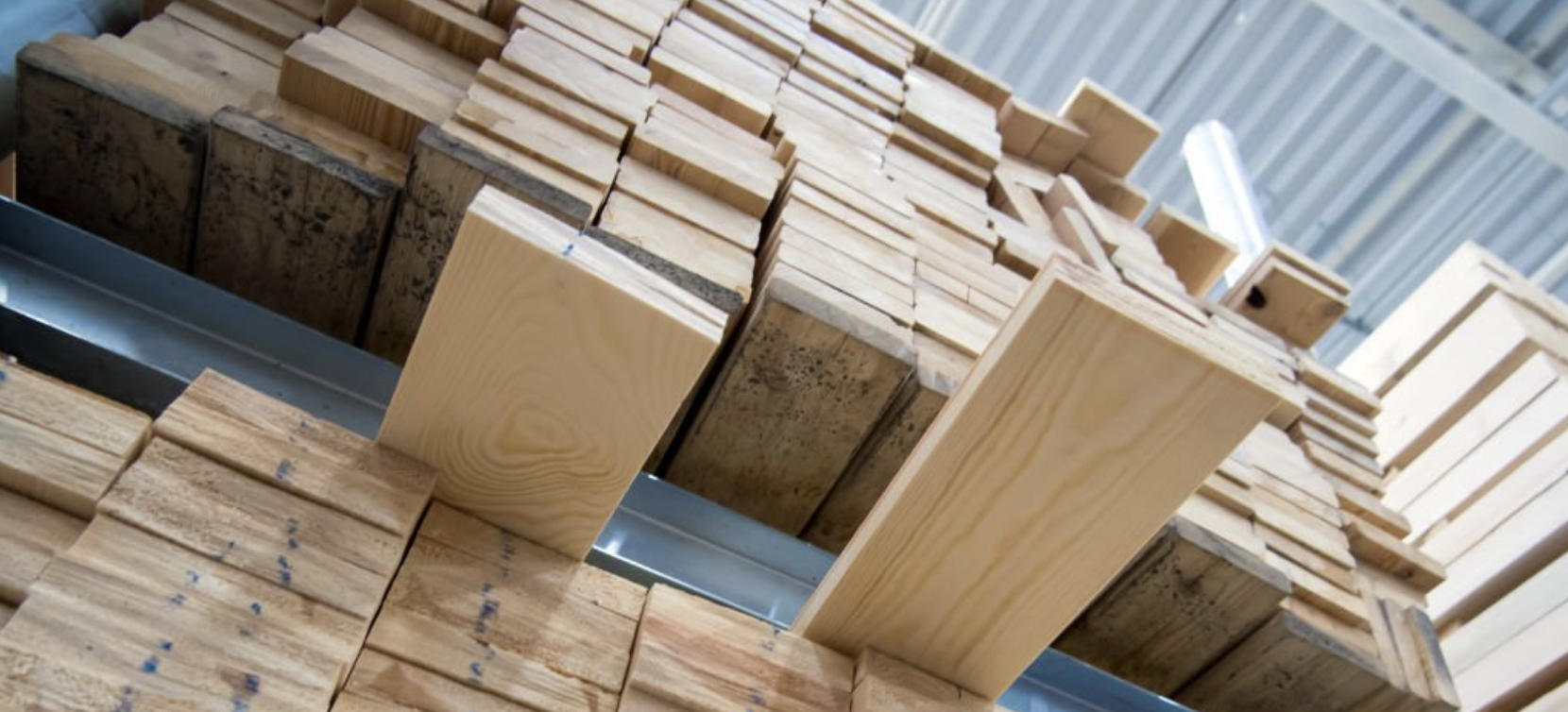 Assorted solid wood panels in light to dark tones, displayed in a fanned layout for material comparison.