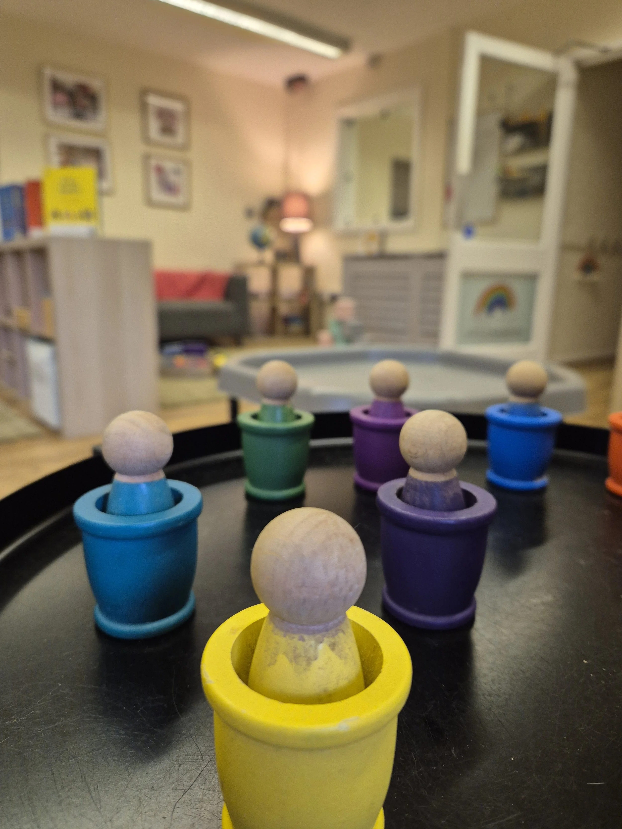 Modern house with wooden exterior, stone steps, and mountain view in the background.